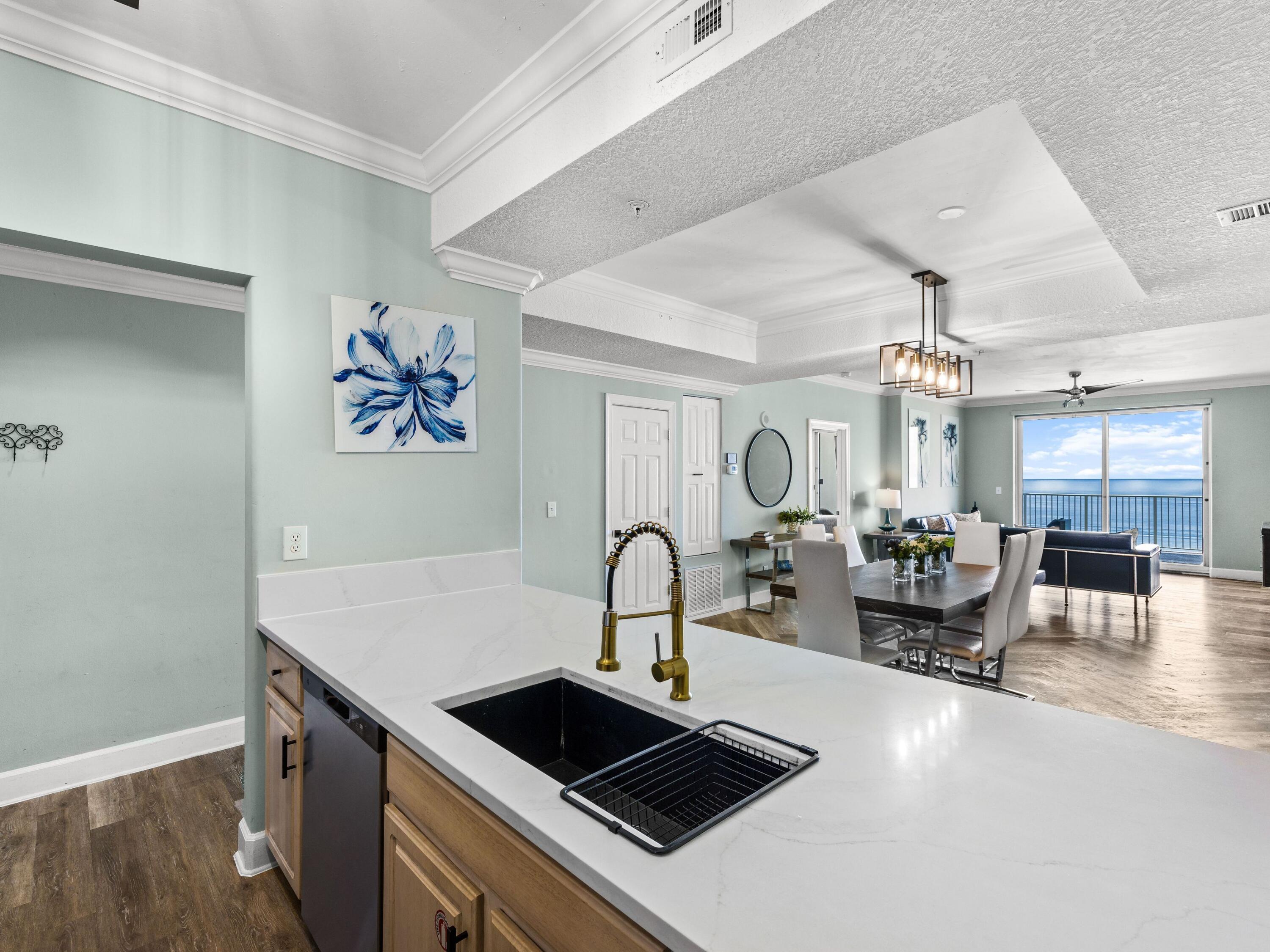 Thirteen floors above the shoreline, the gulf stretches seemingly without end as waves roll toward the beach below and sunsets fill the western horizon. That extraordinary perspective defines this renovated four-bedroom, four-bath residence at Ocean Ritz, where two gulf-front suites and an expansive 300-sq.-ft. balcony place the water at the center of the experience. Generous interiors, thoughtful updates and an established rental history add substance to the setting, creating a coastal retreat equally suited to personal enjoyment and investment.

The open living and dining areas face the water and extend naturally to the oversized gulf-front balcony. With approximately 300 square feet of outdoor living space and seating for eight, the balcony offers ample room for dining, entertaining or simply taking in the shoreline and the sound of the waves below. Its mid-building elevation rises above much of the surrounding street noise while maintaining a close connection to the gulf.

Luxury vinyl plank flooring runs throughout the residence, creating a cohesive look from room to room. The updated kitchen features quartz countertops, stainless steel appliances, a spacious island with bar seating and an open configuration that keeps the kitchen connected to the main gathering areas. An adjacent dining area comfortably seats eight, providing plenty of space for meals and entertaining. Two gulf-front king suites are among the residence's most distinctive features, each offering panoramic water views and an ensuite bath. Two additional bedrooms each include a queen bed and twin bunks, creating flexible sleeping arrangements for family and guests. Four full bathrooms further enhance the functionality of the floor plan, while an in-unit washer and dryer add everyday convenience.

Offered fully furnished, the residence is well positioned for use as a second home, investment property or a combination of both. Its established short-term rental performance includes more than $112,000 in gross rental revenue in 2025. Year-to-date rental revenue is approximately $100,000, with current projections placing full-year gross revenue at approximately $115,000.

Ocean Ritz provides direct beach access, plus a heated community pool, hot tub, sauna, and grilling area. Restaurants and shops are within walking distance, while Shipwreck Island Waterpark, Pier Park and a wide range of Panama City Beach dining, shopping and entertainment are nearby. With four bedrooms, four baths, two gulf-front suites, an exceptionally large balcony and a proven rental history, this updated residence offers a compelling opportunity along the Gulf of Mexico.