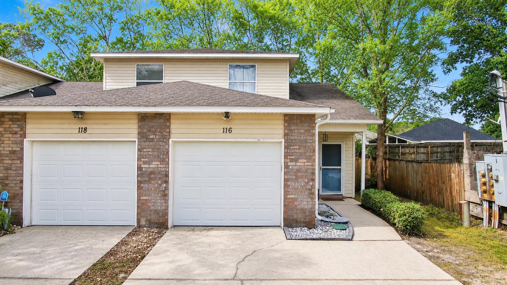 Wonderful location! Recent improvements include HVAC system, water heater, laminate flooring, and carpet on the stairs. End unit with two large driveway spaces for you and your guest or roommate and an attached one car garage. Just 2.2 miles from Hurlburt Field! Impeccably maintained property, freshly painted with a roomy kitchen and an open living space. The main areas showcase beautiful porcelain tile floors for easy maintenance. The primary bedroom is spacious with a walk-in closet and access to the 4-season room. Privacy is ensured with a split bedroom layout, providing ample space for everyone.