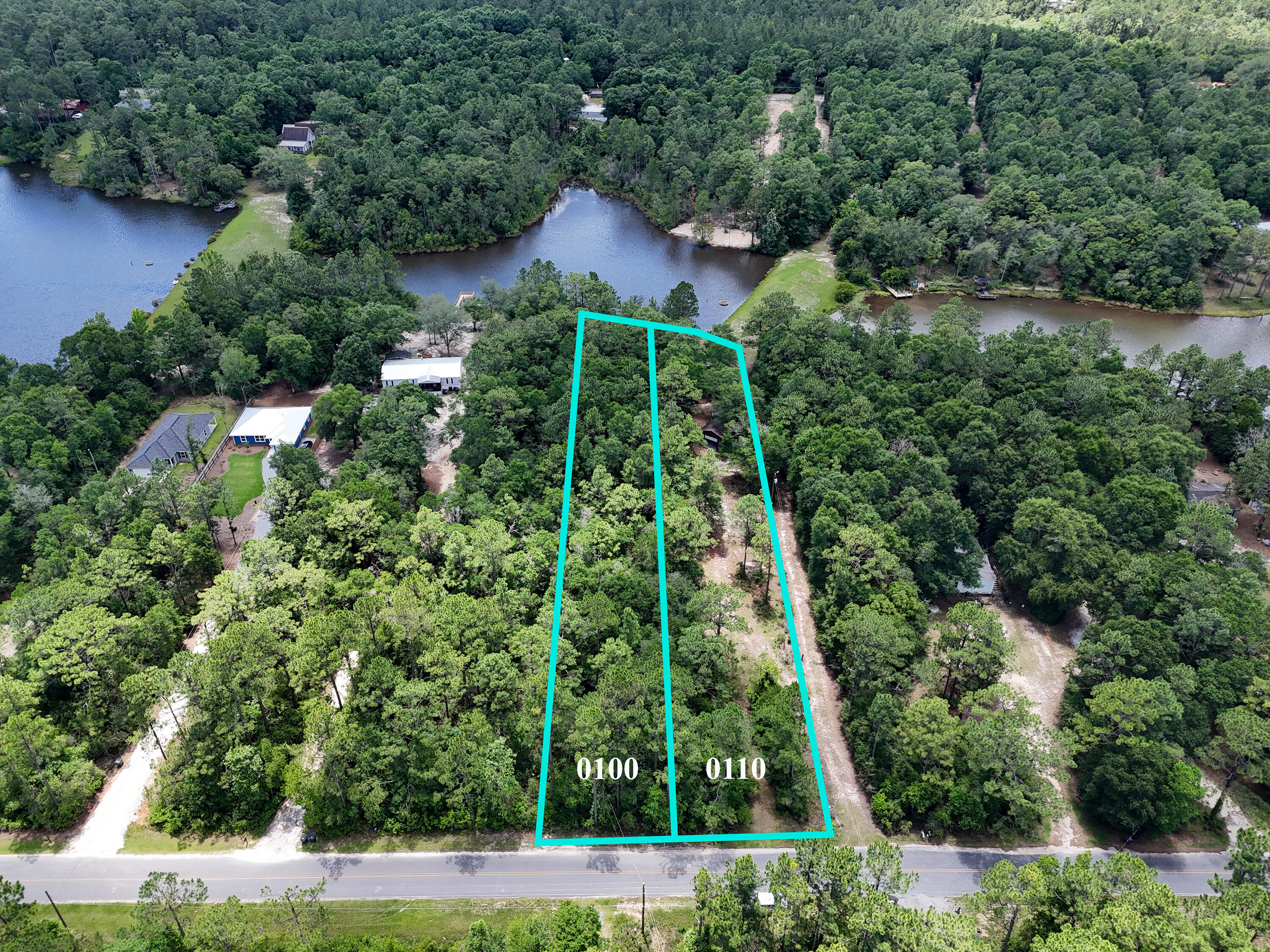 Waterfront Living Starts Here!! Discover the perfect place to build your dream home on these 2 beautiful waterfront lots with septic tank, electricity and city water already in place! Great get-away location with plenty of fishing right out your back door! Property is already partially cleared and has a large workshop ready for all your stuff.  A bunk house and outdoor shower have been started. All measurements must be verified by buyer. Schedule your showing today.