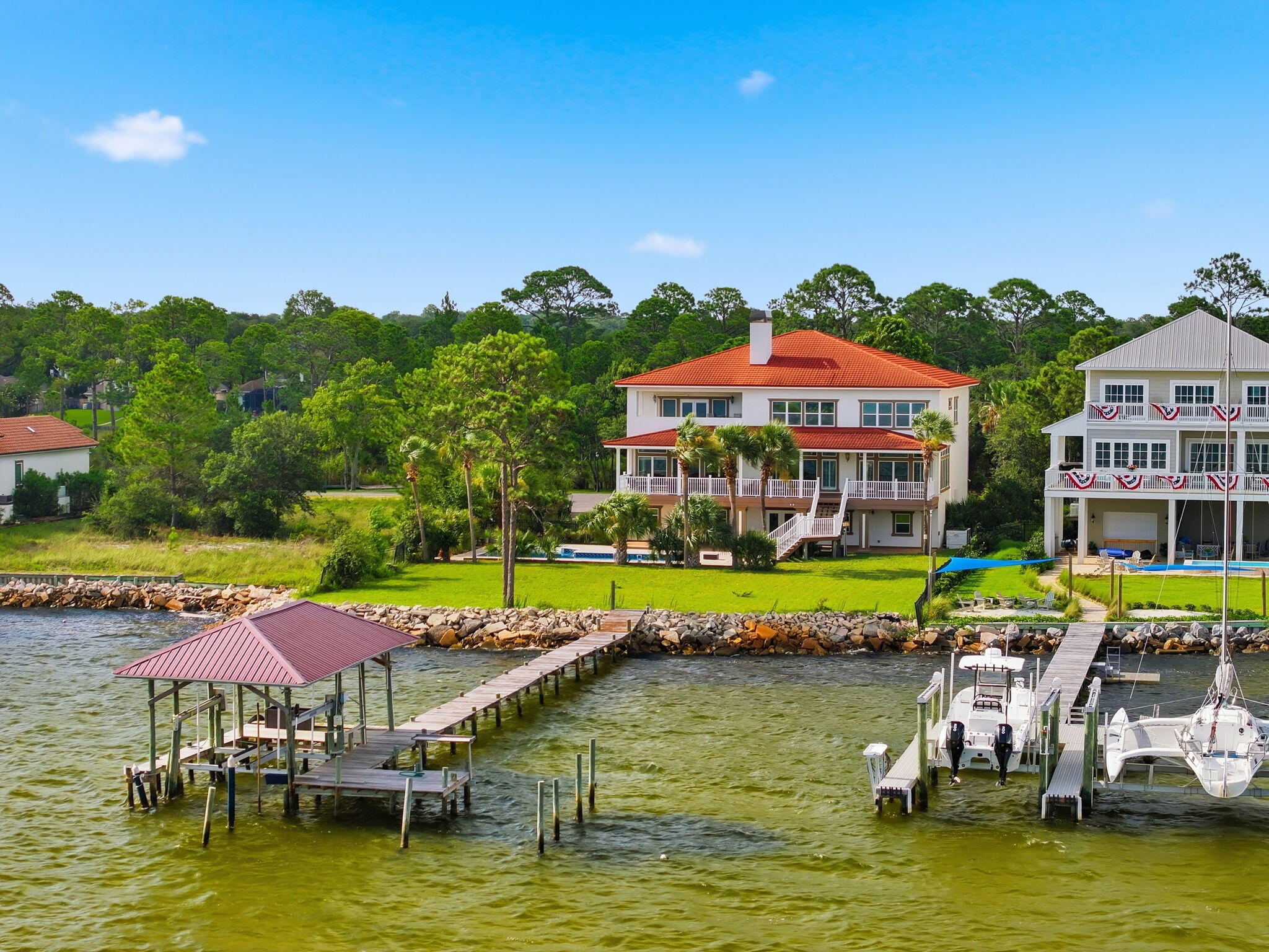 Welcome to Black Pointe, an exclusive gated private island with only seven waterfront estates. Properties on Black Pointe rarely become available, making this an exceptional opportunity to own one of the Emerald Coast's most exclusive private waterfront estates. Situated on approximately 0.85 acres, this extraordinary custom-built residence offers 6,848 square feet of primary living space plus approximately 2,100 square feet of heated and cooled lower-level living area, providing nearly 9,000 square feet of climate-controlled space. The additional heated and cooled lower level offers exceptional flexibility for a fitness room, workshop, guest accommodations, recreation, hobbies, and abundant storage. A rare combination of approximately 105 feet of Choctawhatchee Bay frontage and 125 feet of protected canal frontage provides breathtaking open-water views, secure dockage, and additional space for future floating docks or personal watercraft. Designed to maximize panoramic waterfront views and effortless indoor-outdoor living, the home showcases a grand foyer, soaring ceilings, rich hardwood flooring, quality custom millwork, an elevator servicing all levels, multiple fireplaces, expansive covered verandas overlooking Choctawhatchee Bay. The chef's kitchen features premium stainless-steel appliances, granite countertops, custom cabinetry and generous prep space, opening to spacious living and dining areas overlooking the bay The waterfront primary suite offers a private balcony, panoramic bay views, dual walk-in closets, and a luxurious bath featuring a steam shower and jetted tub.

The thoughtfully designed floor plan includes seven bedrooms, six full baths, and one half bath. The main residence features six bedrooms, five full baths, and one half bath, while a private one-bedroom, one-bath guest suite located off the three-car garage provides exceptional flexibility for extended family, guests, multigenerational living, or a private home office. Additional living spaces include an executive office, multiple gathering areas, a heated and cooled fitness room, workshop, and abundant storage.

Outdoor amenities include a waterfront pool, expansive covered verandas, a generous backyard overlooking Choctawhatchee Bay, and a private dock with covered boat lift. Enjoy direct boating access with approximately a 10-minute boat ride to Crab Island and approximately 15 minutes to Destin Harbor and the Gulf of America, making this an exceptional property for boating, fishing, paddleboarding, and waterfront entertaining.

Built with quality and longevity in mind, the home includes a full residential fire sprinkler system supported by a dedicated 2-inch water service, reflecting the exceptional level of construction and attention to detail throughout the property.

Whether hosting family gatherings, entertaining on the bay, or enjoying a sunset cruise, this exceptional estate offers a waterfront lifestyle that is truly second to none.

This is a rare opportunity to own one of the Emerald Coast's premier waterfront estates, where timeless architecture, quality craftsmanship, and exceptional boating combine to create a true legacy property. With only seven homes on the gated private island of Black Pointe, opportunities to own within this exclusive waterfront community are exceptionally rare.