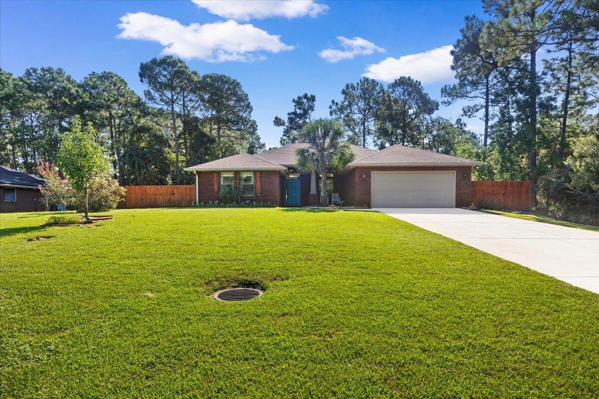 Looking for privacy while still being close to everything? Here it is! Located in the desirable Holley By The Sea community, this inviting home sits on a wooded lot adjoining a natural area, providing a peaceful and private setting.  New steps off of retaining wall.  Pergola and hot tub aded.  Fire pit added.  
Built in 2010, the home offers a wonderful blend of comfort, space and privacy. It features four generously sized bedrooms--all with walk-in closets--and two full bathrooms, both with double vanities. A separate office or flex room offers excellent versatility and could be used for remote work, a quiet study, guest accommodations or a potential fifth bedroom.  New refrigerator, built in microwave and interior paint in 2025.
Low-maintenance luxury vinyl plank and tile flooring extend throughout most of the home. The rear bedroom features newly installed wall-to-wall carpeting.