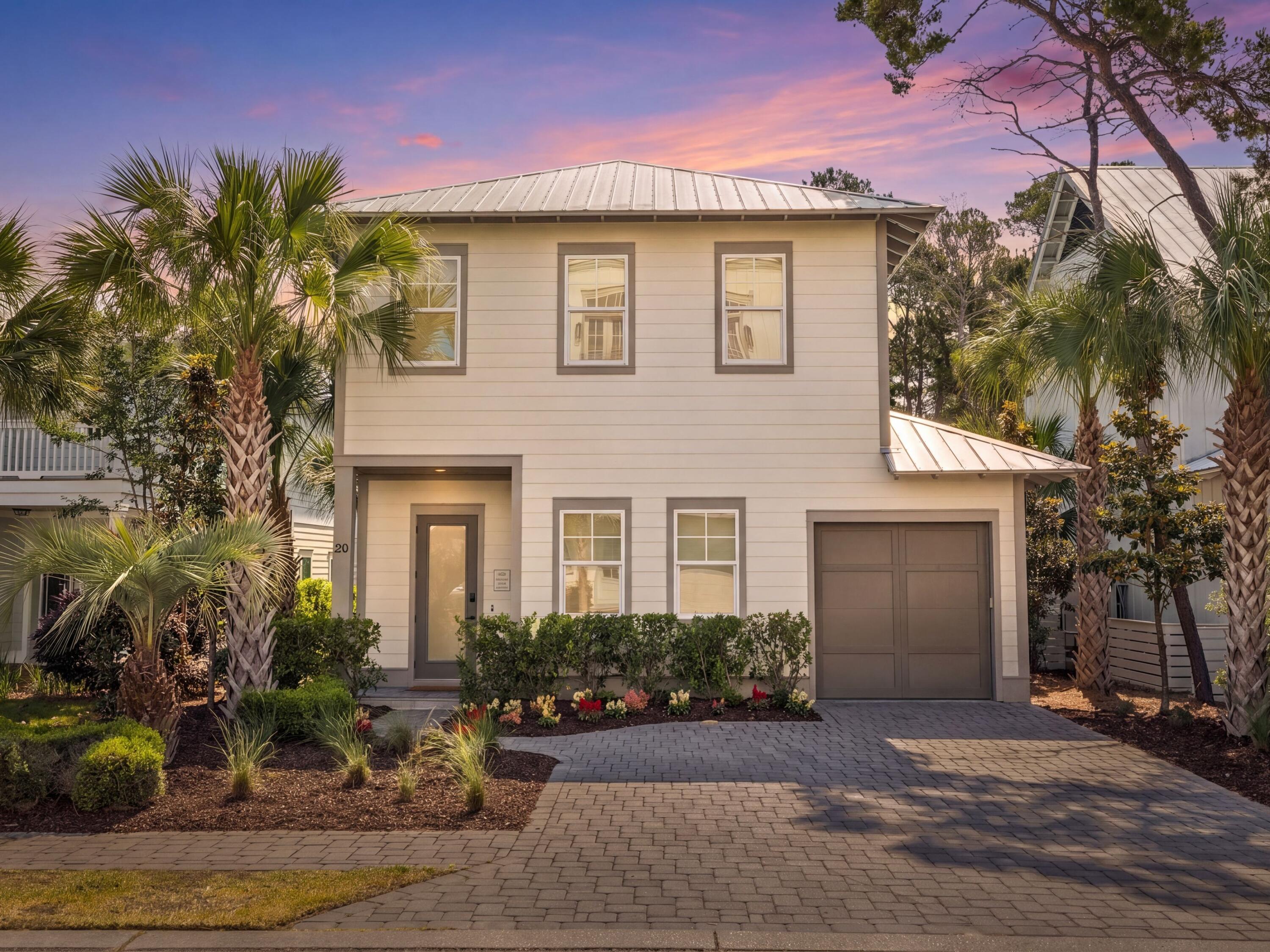 Positioned between the rare coastal beauty of Lake Powell and the white-sand shoreline of Inlet Beach, this thoughtfully designed Grande Pointe residence captures the ease of modern beach living with a polished coastal aesthetic and an exceptional location near the heart of 30A. Built by Focus Construction and presented in like-new condition, the four-bedroom, four-and-a-half-bath home offers approximately 2,300 square feet of living space, pairing clean architectural lines with warm finishes and carefully selected upgrades throughout. Inside, urban and coastal influences come together through 10-ft. stained-wood ceilings, whitewashed brick accent walls, and eight-ft. solid doors and an open-concept floor plan designed for gathering after long days on the water or at the beach. The kitchen anchors the main living space with KitchenAid Pro Series appliances, quartz countertops and custom cabinetry, while the adjacent dining and living areas flow naturally for entertaining and everyday comfort alike. Every bedroom is arranged as an en suite, offering privacy and flexibility for owners and guests, and comfortably accommodates large gatherings or vacation stays.

Technology and comfort have been thoughtfully integrated into the home, including a Brilliant smart lighting system with touchscreen keypads across much of the first floor, an eero Wi-Fi mesh network with three nodes, a 75-inch Samsung frame TV in the living room, Sonos ARC and SUB audio components, Sonos ONE speakers in the kitchen, a Sonos BEAM in the primary suite and Roku smart TVs throughout the additional bedrooms.

Outside, custom landscaping and low-voltage lighting create a striking interplay of shadow and warmth in the evenings, setting the tone after sunset walks back from the beach. Residents of Grande Pointe enjoy direct proximity to Camp Helen State Park, where trails, kayaking and paddleboarding along Lake Powell become part of daily life. From the community dock, owners can launch a paddleboard or kayak and reach the beach in roughly twenty minutes, while the community pool overlooks the lake beneath a canopy of mature shade trees and a tranquil fountain.

Four public beach accesses are located within roughly half a mile, including nearby Inlet Beach Regional Access, known for its expansive shoreline, lifeguards, ADA accessibility, restrooms and generous parking. The pedestrian underpass beneath Highway 98 and Timpoochee Trail makes it easy to bike or cruise along 30A's beach communities. Dining and shopping at 30Avenue are moments away, with local favorites, groceries, boutiques, coffee shops and conveniences at The Shoppes at Inlet all nearby. Whether envisioned as a primary residence, second home or investment opportunity, this coastal-modern retreat offers an effortless connection to the outdoor lifestyle and energy that define this stretch of the Emerald Coast.