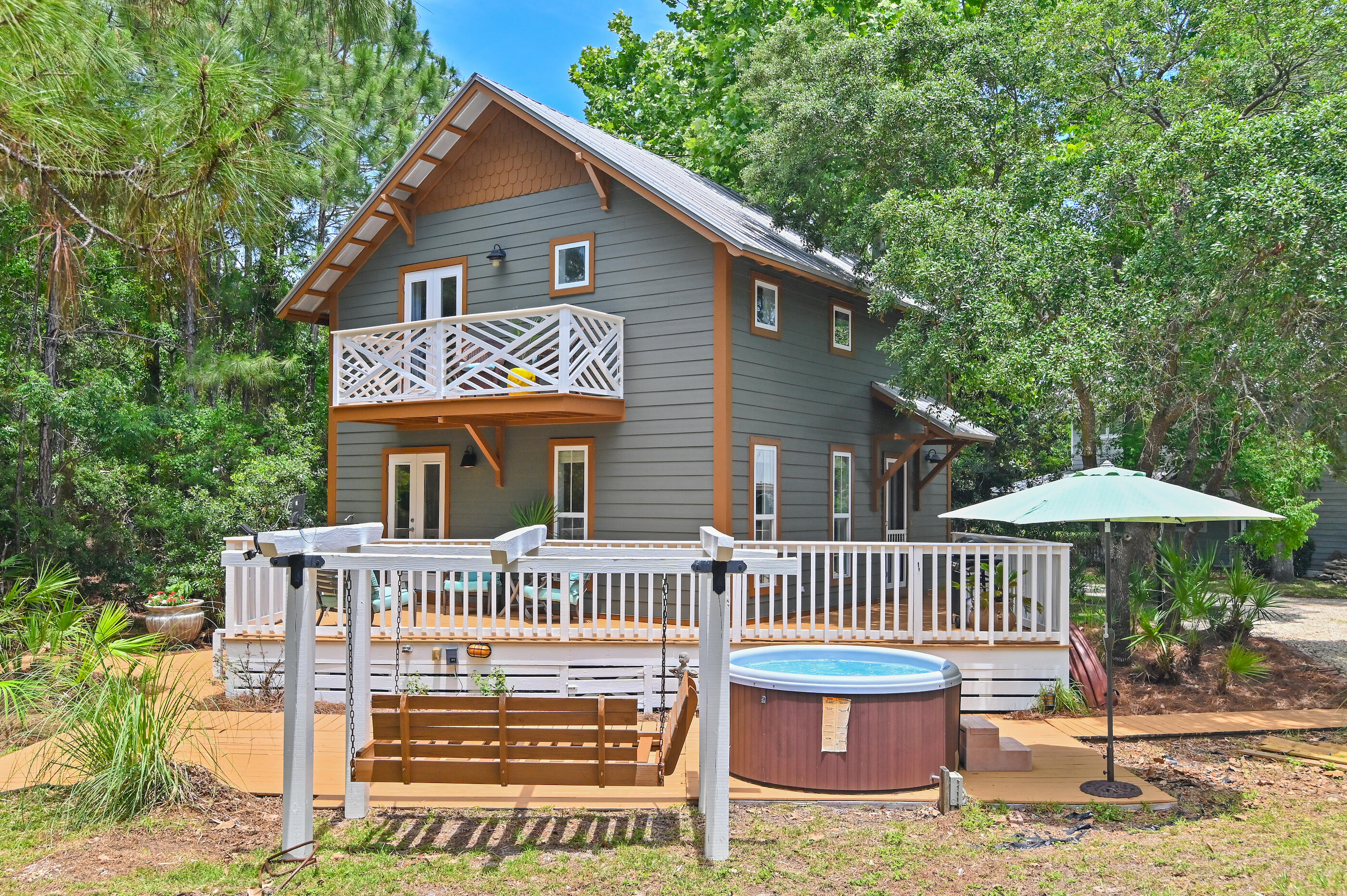 NO HOA AND OVER A HALF ACRE LOT! Bordered by lush vegetation and a picturesque wooded backdrop, 69 Austinwood Lane melds heightened privacy derived from an expansive homesite spanning over half an acre with a prime location on 30A geographically poised minutes from the famed sugar white sand, turquoise hued waters, and the array of dining and shopping venues 30A has to offer. Totaling just under 800 square feet, the charming coastal chalet encompasses an open living and dining area with direct access to the wrap-around porch perfect for enjoying the coastal breeze and overlooking the serene backdrop. Situated on the second level, the bedroom suite features soaring vaulted ceilings, an ensuite with walk-in shower, and a private balcony.

The turn-key rental configuration coupled with the ability to further develop a main residence creates a truly compelling scenario for investors and full time residents alike. The impressive rental potential coupled with the turn-key configuration and recent upgrades create a compelling opportunity for investors and second or full-time residents alike.

The "town center" at Gulf Place featuring Shunk Gulley Oyster Bar, Pizza by the Sea, Renaissance French Restaurant, Coffee Shops, Perfect Pig, Shelbys, Pecan Jacks, Jonah Papa Surfs and local boutiques with walking & biking trails is also poised minutes away. Inquire today to arrange a private viewing and start living the coastal lifestyle you deserve.