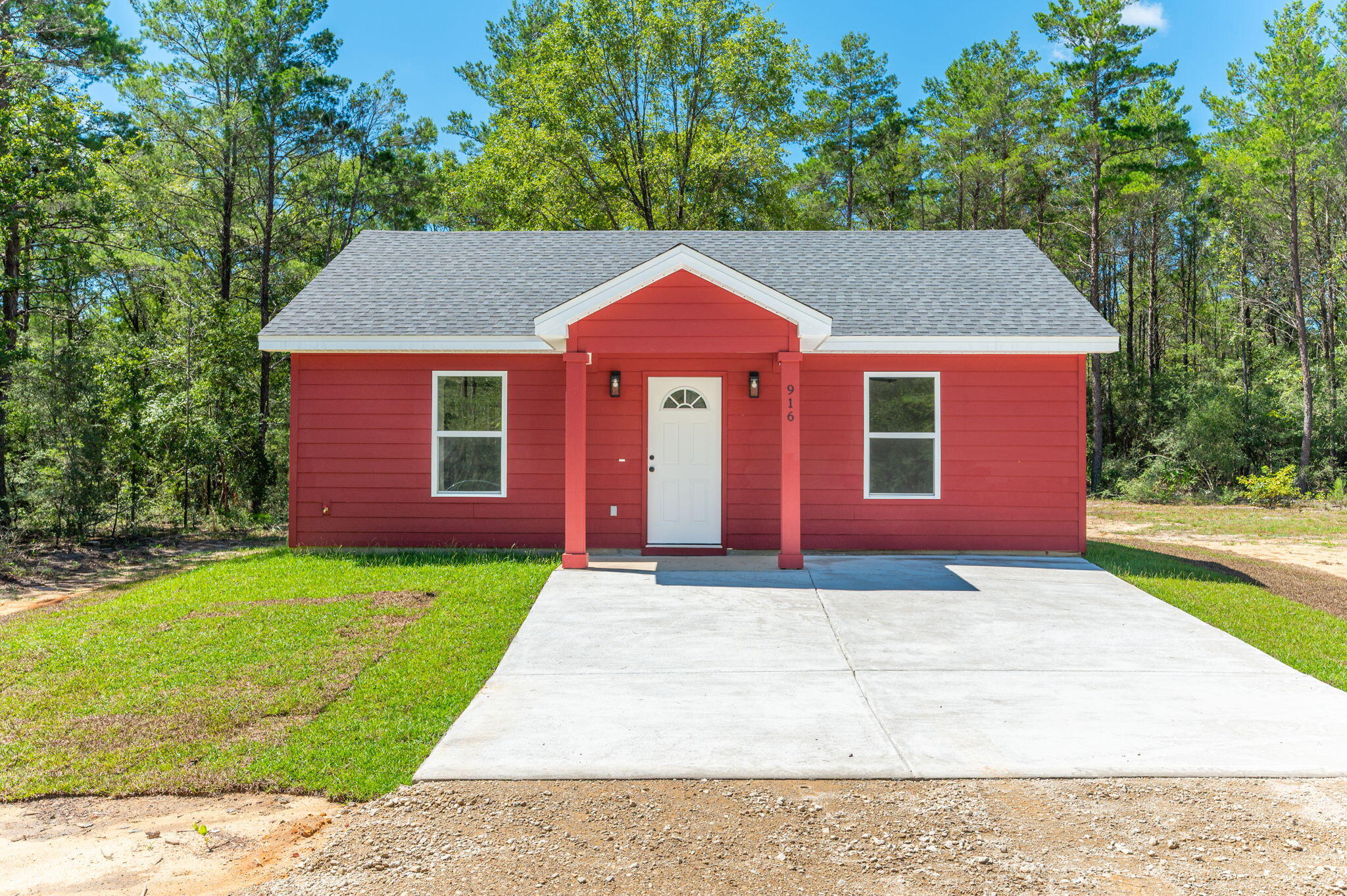 This brand new adorable 806 sq. ft. cottage sits on a ¼ acre lot with access to purchase the adjoining lot if desired. New construction, complete and move in ready. Full of country charm with its barn red and white exterior, wrapped in Hardie Board siding & classic black finishes. There's fresh sod landscaping, a covered front entry, as well as covered back patio perfect for morning coffee or evening winddown. Need parking? No problem. The concrete pad has you covered with gravel extending out to the road. Step inside to an open living space with soaring ceilings, giving you that airy, spacious feel. Luxury vinyl plank flooring runs throughout, because style and durability should go hand in hand. The shaker style cabinets, granite countertops, and stainless-steel appliances along with the interior paint all come together nicely. The two bedrooms are tucked on either side of a full bathroom, featuring a granite countertop vanity and a tub-shower combo, with plenty of lighting. Each bedroom and the living room features a ceiling fan operable by remote including a dimmer for the light. Let's not forget the large laundry room! There is a private well for water and a septic system, which is common outside the city limits.
This charming cottage is big on character, smart on design, and ready for you to call it home! Don't wait, snag this gem along with the possibility of the lot next door as well. Want a fence, more sod or more gravel? Let us know what you're thinking! Whether you Don't wait, snag this gem along with the possibility of the lot next door as well. Want a fence, more sod or more gravel? Let us know what you're thinking! Whether you are looking for a home for only you, your small family, you want to size down, or looking for an investment property, this home might be perfect for you. Contact your favorite realtor today and schedule a showing. Appointment only!