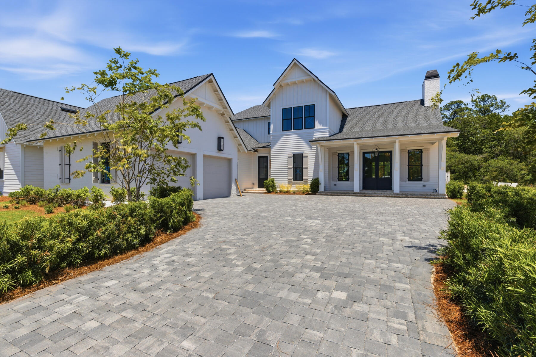 This custom residence by Huff Homes offers 4,200 square feet, 5 bedrooms, 5.5 bathrooms, and a 2-car garage with a dedicated golf cart bay, located on Homesite 55 in Powell Landing West at Watersound Origins. Set on a 140' deep homesite with a wooded backdrop and just steps from the community dock at Lake Powell, the property provides direct access to one of the area's defining natural features. Estimated completion is end of May '26.

The front elevation combines Nichiha siding with brick detailing, leading to a covered entry with brick flooring. Inside, the foyer opens to a central living area, with a private office just off the entry and a dining space positioned toward the rear The main living area is located at the back of the home, defined by vaulted ceilings with exposed wood beams and a wood-burning fireplace. A 16' sliding glass door extends the space to the rear porch, while the adjacent dining area features a 12' slider, creating multiple connections to the outdoor living areas.

The kitchen is centrally positioned between the living and dining areas, anchored by a large island and supported by a walk-in pantry and separate butler's pantry with wet bar. Integrated cabinetry conceals a full appliance suite including a dual fuel range, multiple refrigeration units, and additional beverage and ice storage.

The primary suite is located on the main level with direct access to the rear porch and includes a freestanding tub, walk-in shower, and built-in closet storage. Additional first-floor bedrooms are positioned toward the front, while the laundry and mudroom connect to the garage and golf cart bay for everyday functionality.

As you ascend the stairs, detailed with iron handrails, white oak posts, and integrated stair lighting, three additional bedrooms are arranged around a central sitting room. Ceiling heights of 11' on the first floor and 10' on the second floor maintain consistent volume throughout.

Outdoor living is centered around a 30' x 12' pool with a spa, screened porch with roll-screens , summer kitchen, and fireplace extending the living space and taking advantage of the depth of the homesite.

Additional features include wide-plank wood flooring, white oak interior doors, crown molding throughout, upgraded fixtures, whole-home dehumidification, a conditioned garage space, and epoxy-coated garage flooring.

Located within Powell Landing West, this home offers immediate access to Lake Powell, the community dock, and Watersound Origins amenities including trails, Village Commons, and the Origins Golf Course.