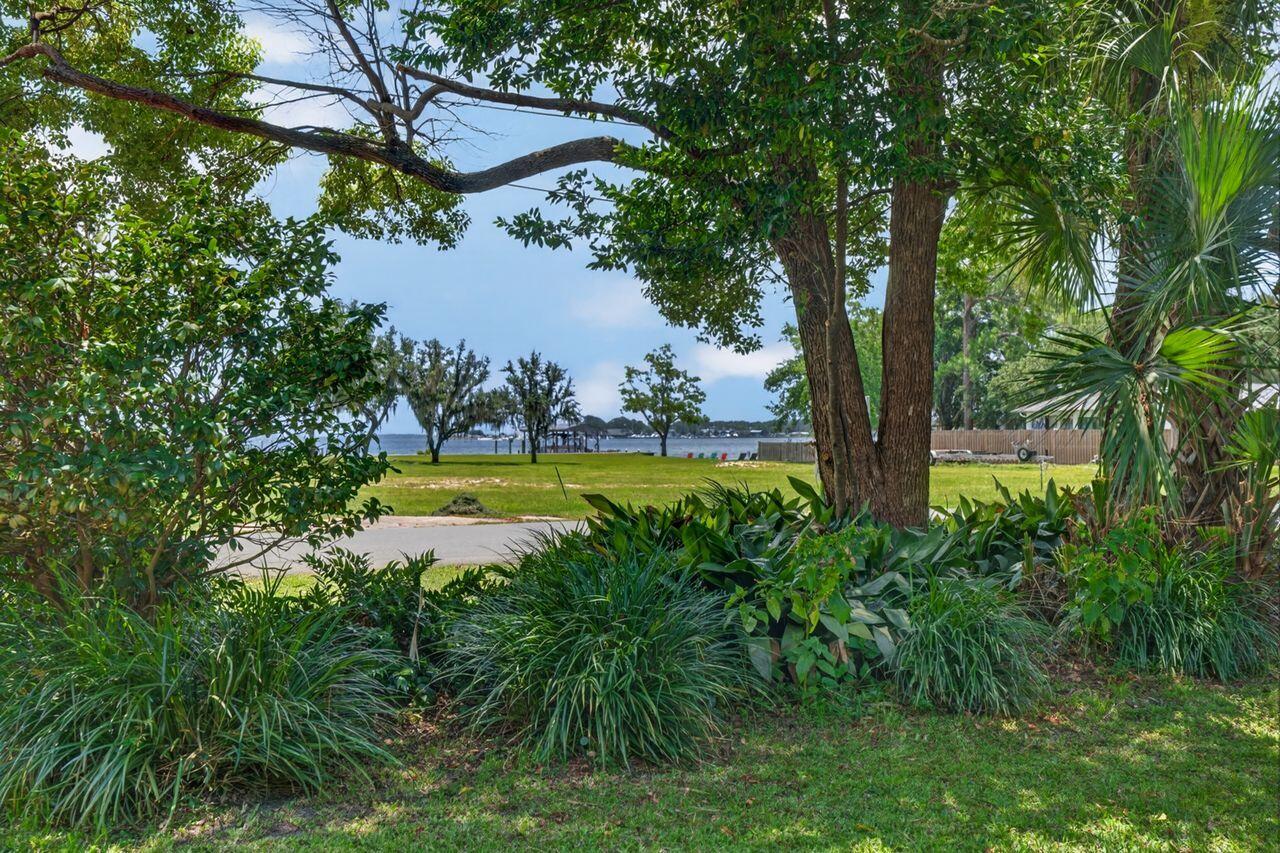 WITH ACCEPTABLE OFFER SELLER WILL HAVE NEW SHINGLE ROOF INSTALLED PRIOR TO CLOSING!  Vintage 3BR/2BA Florida cottage features incredible, panoramic view of Cinco Bayou, Fort Walton Yacht Club and Shalimar Point! After you've taken in the view, enjoy the highlights which include original hardwood...screened porch...lush, dense backyard with ornamental pond...one-car garage...distressed-brick drive...white/gray kitchen with tile backsplash & quartz countertops...kitchen pass-through to Dining Room & built-in shelving and cabinetry! Conveniently located in the heart of Fort Walton Beach!  Neighborhood includes a waterfront City Park close by with shallow boat ramp, perfect for jet skis, paddleboards or small boats! Just minutes from sugar-white, sandy beaches, restaurants, shopping, Okaloosa Island Pier, boating, paddle-boarding & more! You will love the neighborhood...perfect for walking, bicycling, swimming, picnicking and making new friends!