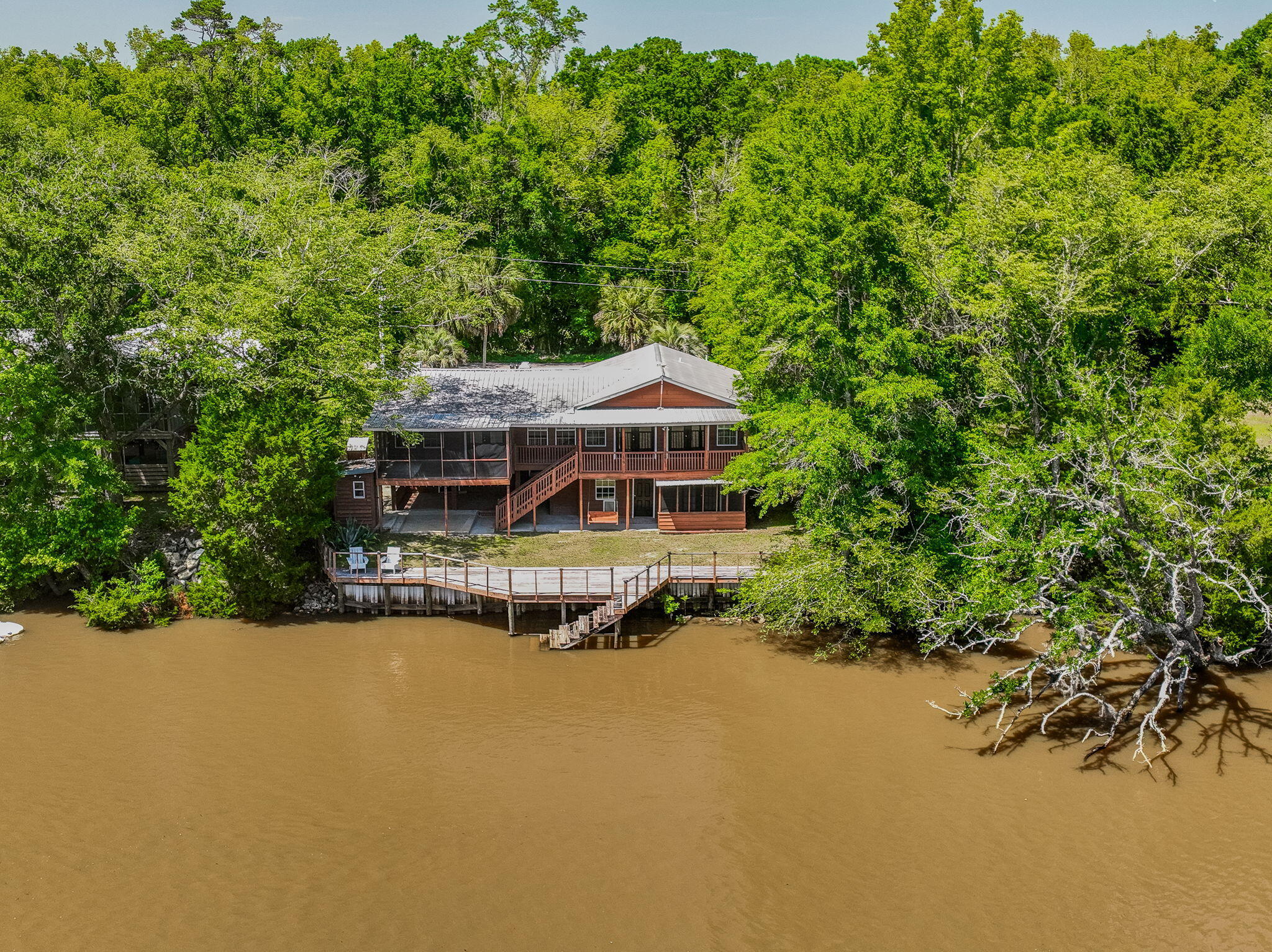 PRICED 35K BELOW 9/2025 APPRAISED VALUE!  AFFORDABLE WATERFRONT w/SEPARATE APARTMENT, Just 35 miles to BWB &  30 miles to 30A!  NEW ROOF, HVAC, HWH, WELL & PUMP, & SEPTIC LIFT STATION provide affordable insurance & peace of mind. Seller's job transfer fell thru so Seller needs to sell. Tired of traffic & tourist traps? Dreaming of a peaceful retreat without giving up the beach & civilization? Ideal as a primary Home, 2nd home, or investment property, this Cedar Sided, 2 Story RIVER CAMP on .21 acre serene landscape is Calling Your Name!  Spend your days gazing out at Choctawhatchee River, taking a boat or jet ski out for a ride, or fishing right from your deck. A soaring ceiling, original hardwood floors & giant open-concept living area accent the 2nd-Floor Primary Residence (1,440 SF) The huge living space w/cozy wood-burning fireplace & custom built-in bookcases flows seamlessly into the updated kitchen with multiple dining areas, ideal for both entertaining and daily life. The spacious Kitchen Island Bar, topped with lovely granite, is the perfect spot to watch the chef in action or gather with friends. The kitchen includes ample storage in white wood cabinets, SS appliances, side-by-side refrigerator, deep double-bowl sink & dishwasher. Tucked off the kitchen is the Master Bedroom with an En Suite remodeled Bathroom w/ new vanity, toilet & tiled walk-in shower. A laundry area with washer and dryer hook-up is also included.

From the back of the home, enjoy sweeping river views, a picture-perfect backdrop for everyday living. This truly special home embraces the outdoors with multiple outdoor living areas designed for relaxation. Turn the 2nd floor screened porch into a secondary living area or additional bedroom, or step onto the expansive covered deck to unwind and take in the awesome views.

On the ground level, relax on the covered porch swing or step out to the massive deck extending the majority of the 71 feet of river frontage. Fish, relax, or even add a dock for your personal watercraft, the choice is yours.

The Ground Level also features a separate 1-bedroom, 1-bathroom apartment with a walk-in closet, space for a kitchenette, & a screen-covered porch. An additional Separate Bonus Room could be used as an Office, Bunk Room, Hobby Space, or overflow Storage.

An extended-length 1-car garage provides plenty of room for a vehicle, & possibly even an ATV or side-by-side. The property has its own private well with a filtration system located in the outbuilding and is on septic. 

Don't be fooled by this serene location, this Home Offers Close proximity to Freeport, Niceville, Beaches, Grand BLVD & 30A! Plan a visit right down the road to Tree House Farms, a local Organic Farm, offering fresh produce & a stunning backdrop for weddings & private events. Plan a Picnic or Launch a Watercraft for the day cruising the Choctawhatchee River, at Cowford Landing Park & Boat Launch. 

Explore the possibility of turning the home into an AirBnB or rental property for others looking to escape! Learn about the uniqueness of our ecosystem at E.O. Wilson Biophilia Center. Make a playdate with a four-legged friend at Alaqua Animal Refuge. Spend the day at the Beach or Explore one of the State Parks!

Seclusion with Close Proximity to it ALL!
Tree House Farms - Local Organic Farm & Wedding / Private Event Space located 1.9 miles
Cowford Landing Public Park & Boat Launch - 4.8 miles (245 Big Cedar Rd) Offers Boat Launch, Screen Covered Deck, Public Restrooms, & Picnic Tables
Alaqua Animal Refuge - 9.2 miles
E.O. Wilson Biophilia Center - Just over 10 miles
Publix Super Market at The Shoppes at Freeport - 14.3 miles
Eden Gardens & Point Washington State Parks - within 28 miles
Grayton Beach - 27.5 miles
Rosemary Beach - 30.6 miles
Grand Blvd 32 miles
ECP Airport 22 miles
Closest Public Beach Access 58 Panama City Beach - 23.4 miles
Blue Mountain Regional Beach Access - 26.9 miles