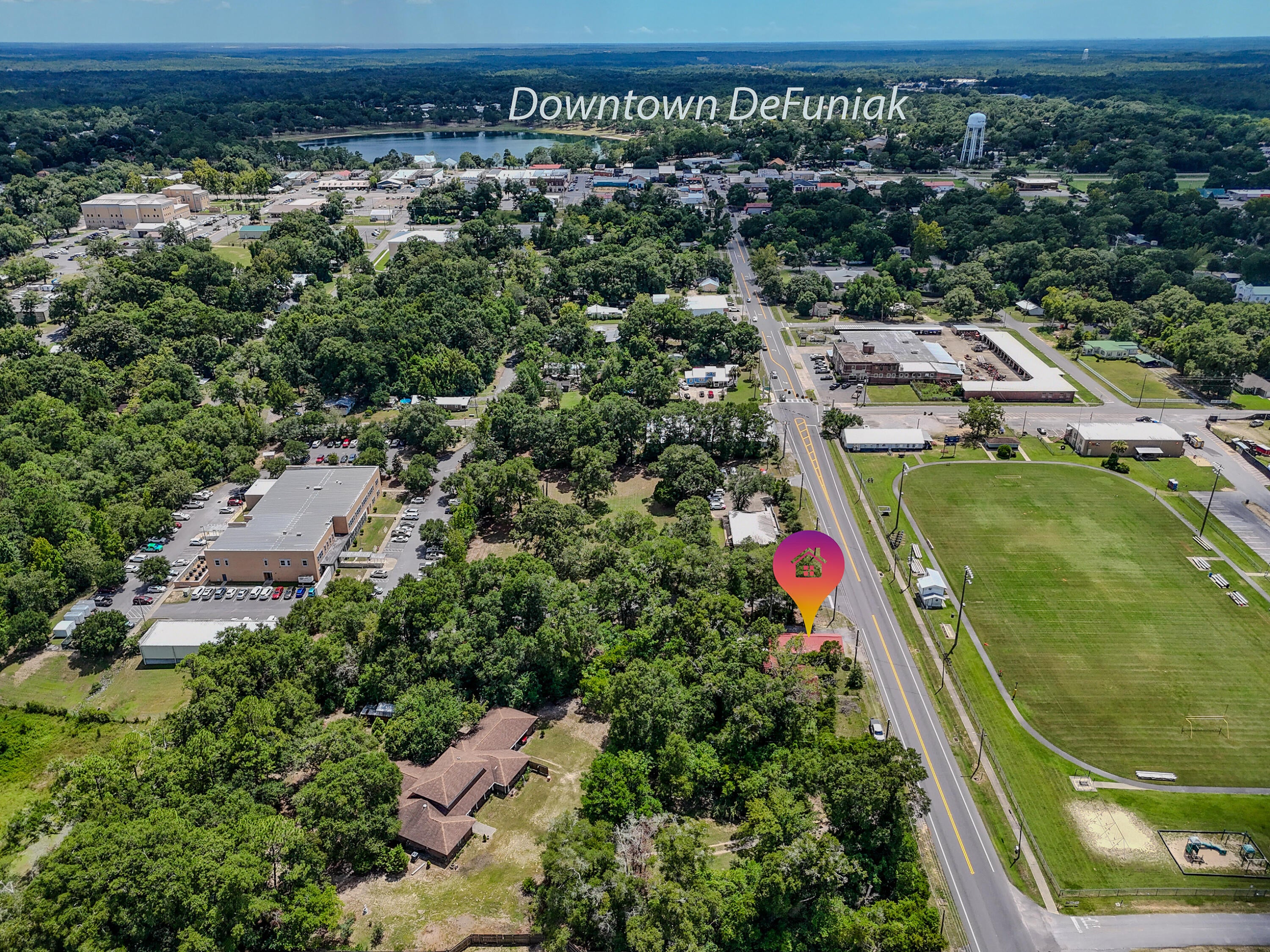 Located in downtown DeFuniak Springs, directly across from Harbeson Field, 5 blocks north of Hwy 90 on St Hwy 83 (aka N 9th St). A unique opportunity to use this as both residential and commercial with city approval. Live upstairs, work downstairs. Currently zoned C-2 with Future Land Use as LDR, Low Density Residential (documents attached). Whether you have a wild, artistic side - or you've always had the innate ability to see what a property COULD BE - this storybook 1939 cottage is a seriously cool project. But don't read ''project'' as dilapidated. No, no - this property actually feels incredibly solid. The tongue-and-groove is practically everywhere, and the arched door frames lend character you simply can't recreate. The cottage is over 2300SF with spacious rooms - and the upstairs has the potential to be an amazing apartment or simply additional office space. Is she covered in vines? She is. Is she also covered in possibilities? Absolutely she is. Don't dismiss this one if you're the creative type, an investor looking for a new flip, or the entrepreneur looking for a new location for your business. The city currently offers 50-50 matching grants through the CRA for both residential and commercial, with up to $15k for exterior improvements (defuniaksprings.net for details; conditions apply). Sharply priced to attract buyer attention. Cash or conventional financing only.