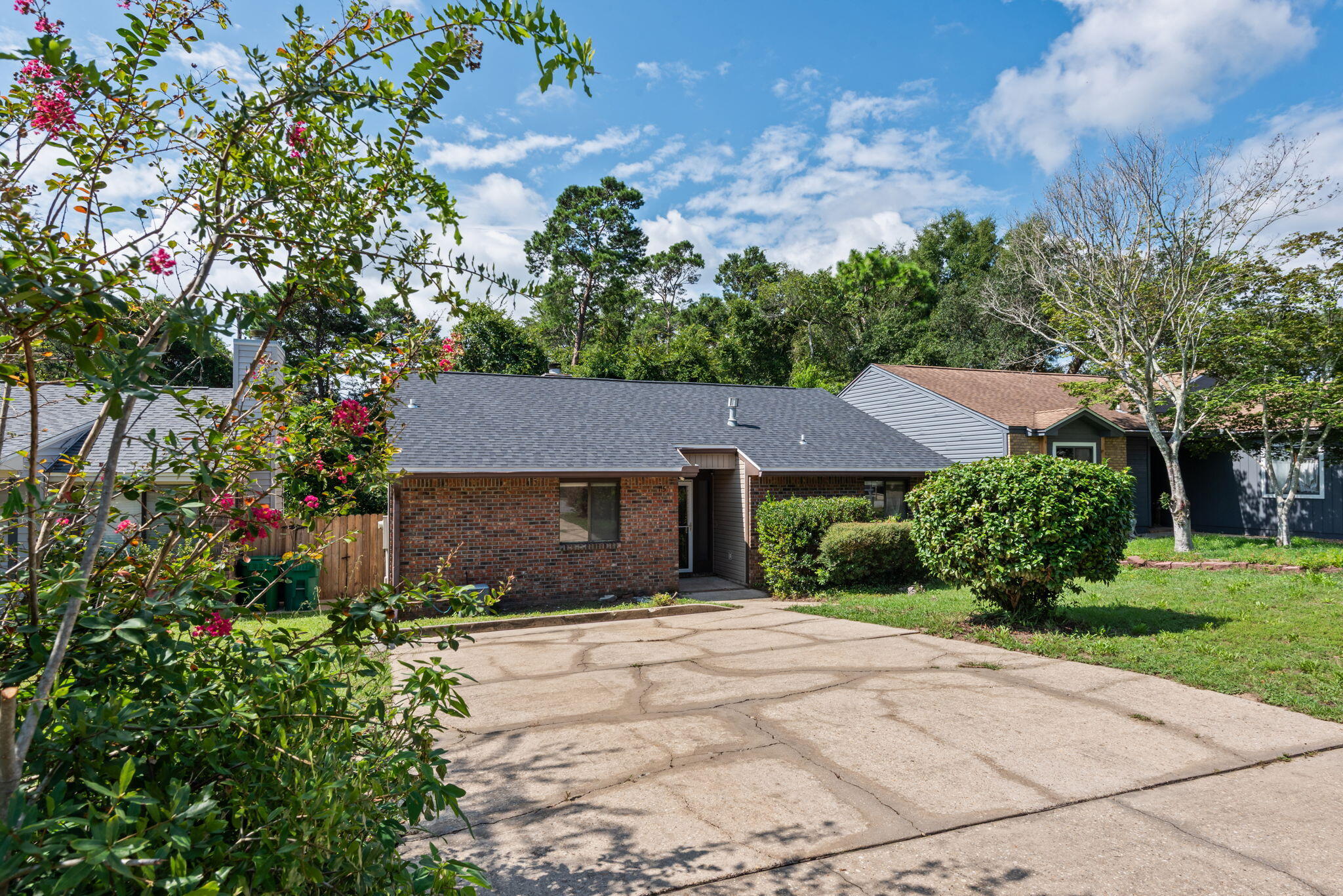 Move-in ready and beautifully updated, this charming 2-bedroom, 2-bath home in Cedar Ridge offers bright, inviting living spaces and an exceptional location within walking distance to Northwest Florida State College. Fresh interior paint throughout and new luxury vinyl plank flooring in the living room, dining area, & both bedrooms, create a clean, modern feel, while ceramic tile in the kitchen, entry, and bathrooms provides durability and easy maintenance.
The spacious living room features a soaring vaulted ceiling, abundant natural light, a cozy wood-burning brick fireplace, and custom built-in shelving. The thoughtfully designed kitchen is equipped with new appliances, including a gas stove, side by side fridge, dishwasher, & microwave, and is complemented by an oversized pantry that provides exceptional storage. A dedicated laundry room and two linen closets add to the home's functional layout.
Enjoy peace of mind with a new roof and new water heater, both installed in 2026. Step outside to a large open deck that includes brand new decking and staining and overlooks a peaceful wooded backdrop, offering a private setting to relax or entertain. No neighbors behind you! Flowering trees enhance both the front and back yards, while the privacy-fenced backyard provides the perfect balance of beauty and seclusion.
 Filled with natural light and thoughtfully updated throughout, this cheerful home combines comfort, convenience, and low-maintenance living in a desirable Niceville location! Come see this gem today!