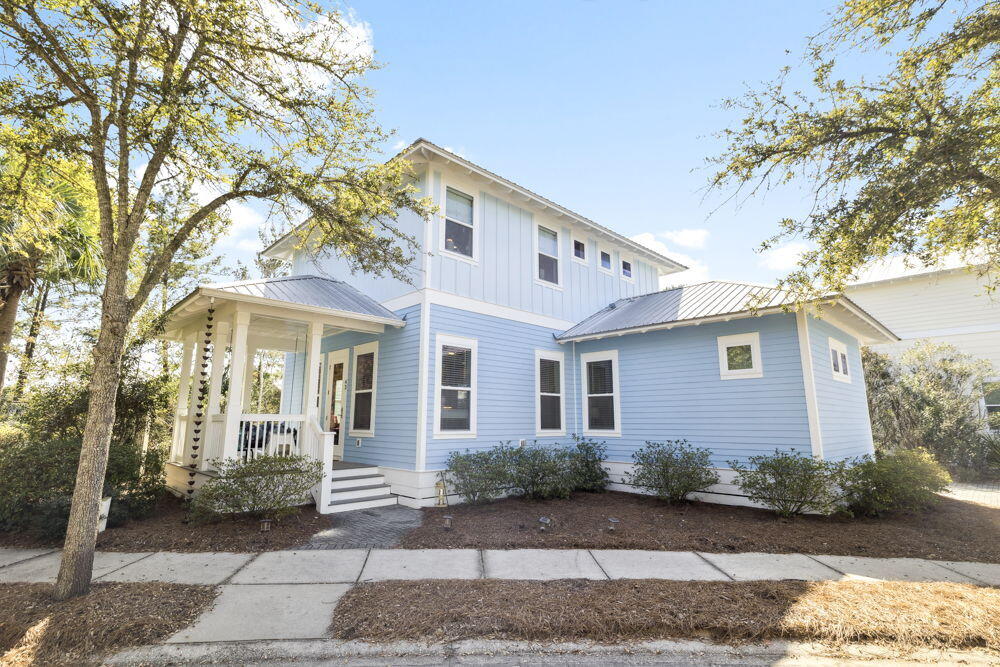 Classic coastal design meets relaxed 30A living in this thoughtfully designed 4-bedroom, 4-bathroom home with an additional flex room that can serve as an office, bunk room, or extra sleeping space. The floor plan offers two primary suites--one on each level--along with two additional bedrooms, each with its own private bath, creating a layout that offers comfort and privacy  

The open-concept living, dining, and kitchen area is bright and welcoming, ideal for everyday living and entertaining. The kitchen features custom white cabinetry, stainless appliances, white marble countertops, and a spacious island, accented by a sea-glass inspired tile backsplash. Hardwood flooring runs throughout both levels, with classic tilework in the bathrooms. Outdoor living begins with the covered front porch, a relaxing spot to enjoy the coastal breeze. Additional features include a dedicated first-floor laundry area, generous custom closets, and a freestanding storage building for beach gear and bicycles.

The home is conveniently located near Greenway Station, where you can enjoy restaurants and shops, and is also close to the sugar-white sand and turquoise blue waters of the Gulf. 

A versatile coastal home for sale offering style, functionality, and an ideal 30A location.