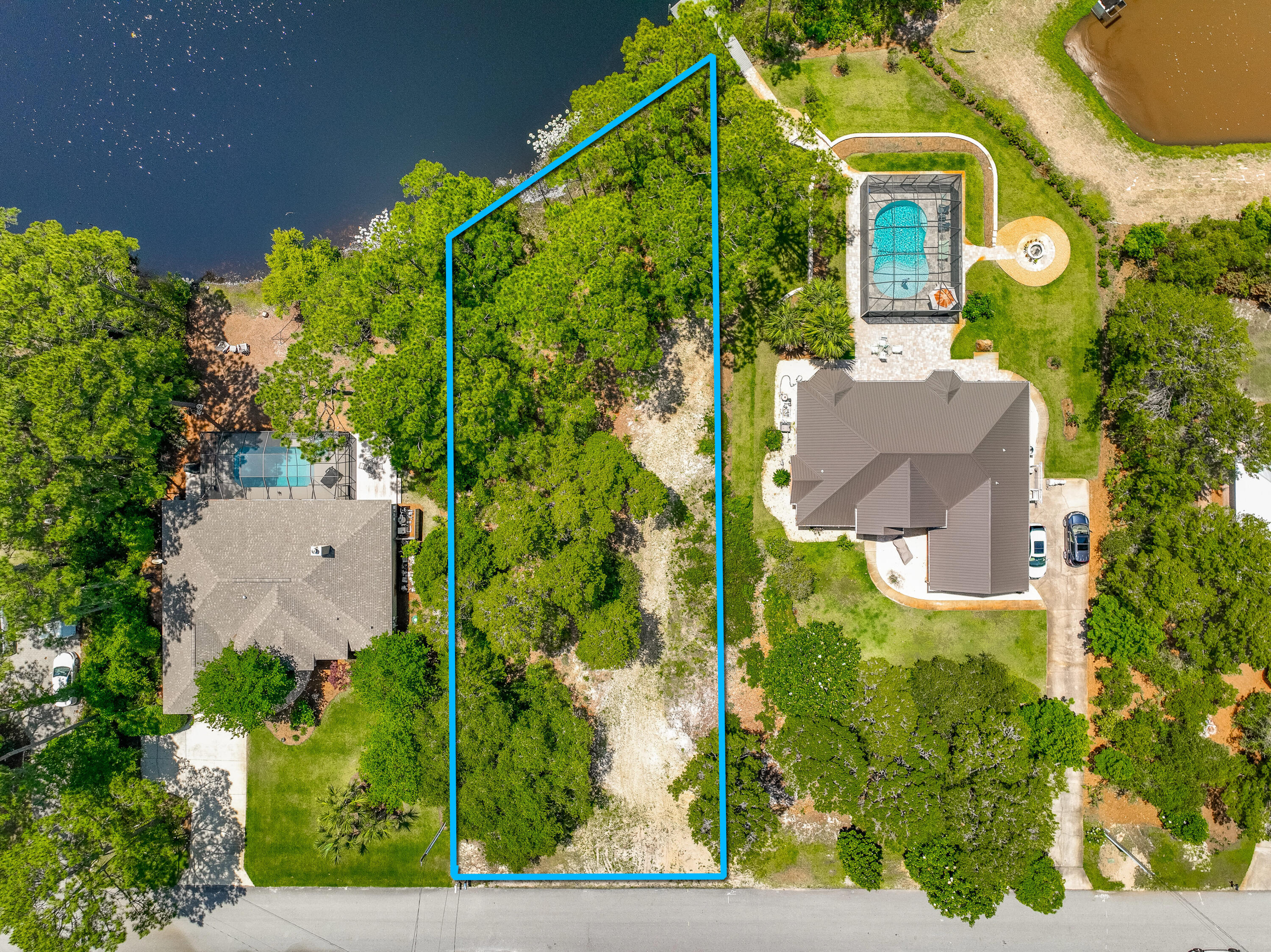 This is the last lake lot available in Santa Rosa Ridge  and one of the finest building opportunities remaining in all of South Walton. Sitting on approximately 0.52 acres of prime Fox Lake frontage, this naturally elevated lot offers beautiful views of Fox Lake and a topography that is exceptionally rare in coastal Florida.
Everything a buyer needs to break ground is already in place. Water and sewer tap fees are paid and installed. A Walton County building permit is in hand along with completed architectural plans for a 4,445 square foot custom home  saving the new owner tens of thousands of dollars and six to twelve months of permitting delays. There is no HOA and no build-out requirement. This lot is ready when you are.
Santa Rosa Ridge is one of Santa Rosa Beach's most established and sought-after communities, just a short distance from the sugar-white sand beaches of South Walton, with Gulf Place shopping and dining just a golf cart ride away. Public beach access is close by, and the neighborhood's proximity to Scenic Highway 30A puts world-class restaurants, boutiques, and the full 30A lifestyle within easy reach.
The lot is partially cleared with beautiful twisted oaks and pine trees remaining along the eastern side, offering natural privacy and the opportunity to preserve the character of the land while building your dream home. Fox Lake frontage of this size and quality in this neighborhood does not come available twice.