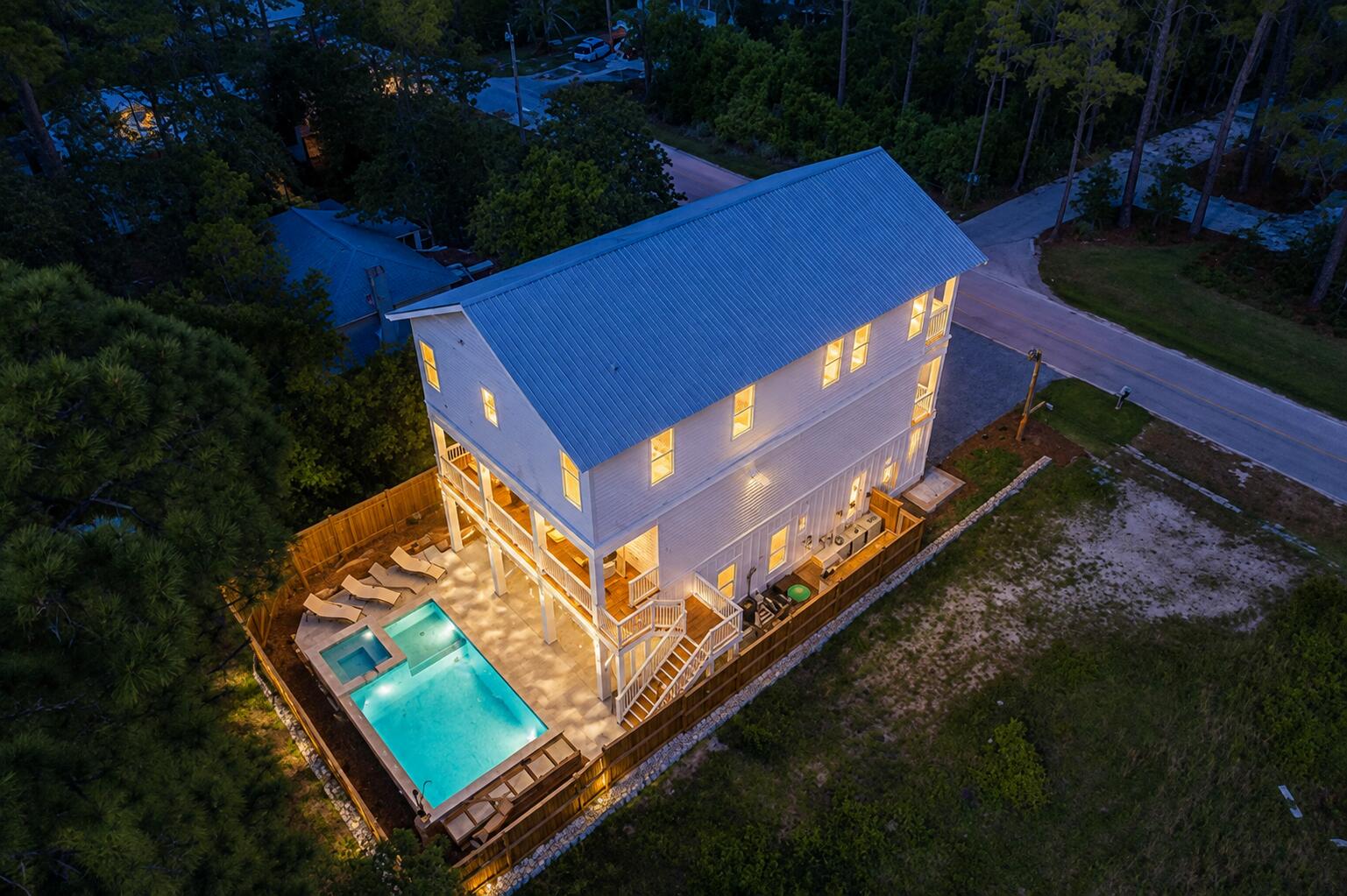 Experience elevated coastal living in this newly constructed 5-bedroom, 5.5-bath retreat, ideally positioned near the sugar-white sands of 30A. Spanning three thoughtfully designed levels, this exceptional home combines refined finishes, generous gathering spaces and outstanding privacy with a peaceful nature preserve bordering the backyard.

The open-concept living area is highlighted by soaring ceilings, exposed wood beams, abundant natural light and a designer kitchen featuring an oversized island, premium appliances and ample space for entertaining. An elevator provides convenient access to every floor, while multiple oversized balconies offer tranquil treetop views and inviting outdoor living spaces.

Designed to comfortably accommodate large families and guests, the home features three king suites and two spacious bunk rooms. Outside, a private resort-style setting awaits with a heated pool and spa, expansive paver patio, covered lounge area and fully equipped outdoor kitchen. Custom fencing and a privacy wall create a secluded backyard oasis.

Additional highlights include a two-car garage, parking for up to five vehicles and convenient access to nearby beaches. Whether enjoyed as a primary residence, second home or luxury vacation rental, this turnkey coastal retreat delivers the space, privacy and amenities buyers seek along Florida's Emerald Coast.