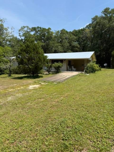 Solid Brick Home Close to I-10 and Hwy 90. This Home was 3 Bedrooms - the Seller Took Walls Down and They Could Easily be Added Back. Metal Roof! The Large Yard Gives you Plenty of Room to Grow Your Home or Your Garden! There is a Metal Carport Separate from the House with A Metal Shed Attached. Bring Your Riding Lawn Mower! A Double Gate at the Left Side of the Back Yard Makes for Easy Access. Buyer to verify all measurements and pertinent information.