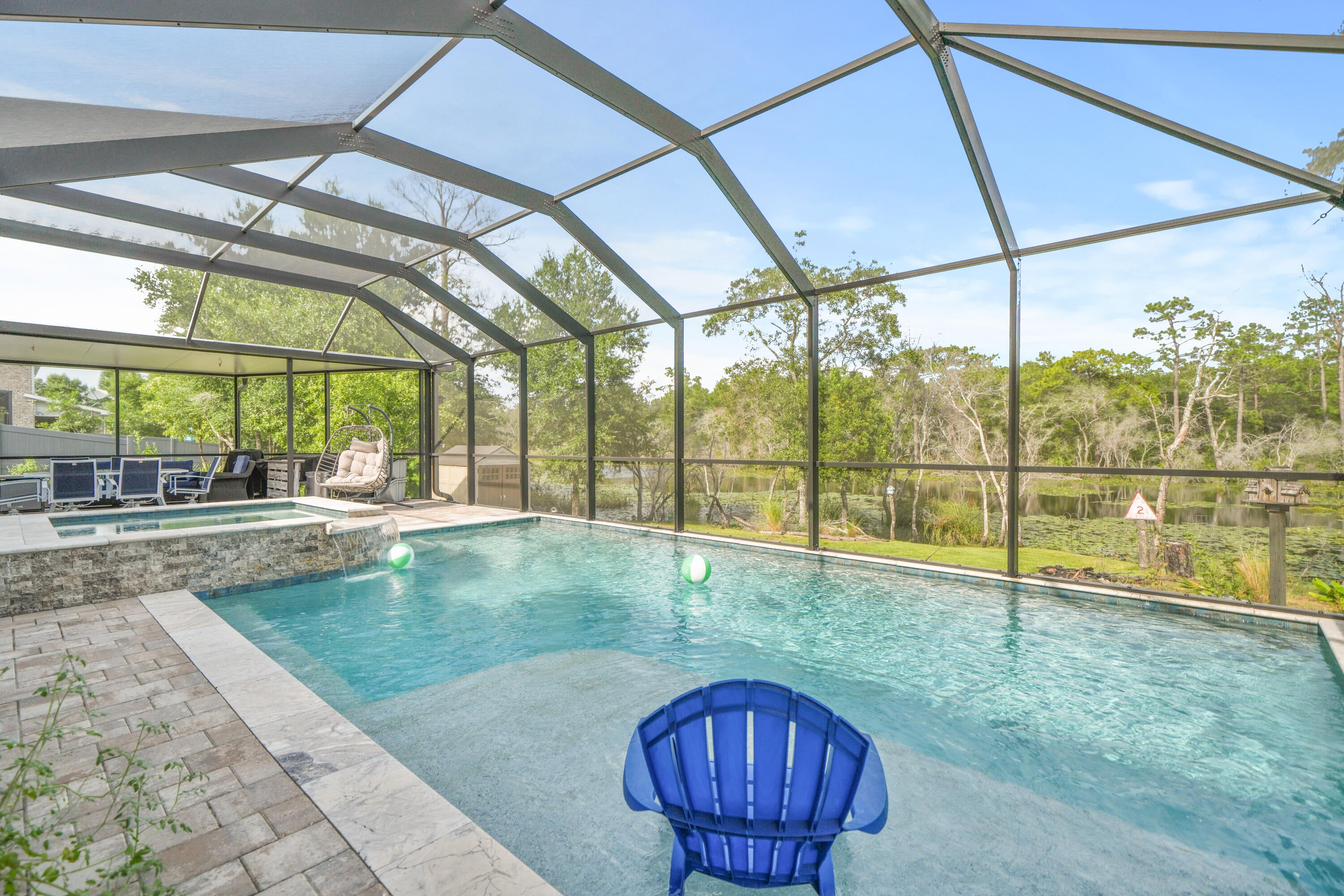 Vacation every day in this beautifully updated home, where a resort-style heated pool and jacuzzi, premium upgrades, and thoughtfully designed living spaces create the perfect place to relax and entertain. Perfectly positioned on a cleared premium lot backing up to a tranquil lily pond, the backyard offers water views, added privacy, and the ideal setting to enjoy an outdoor lifestyle. Just minutes from the area's beautiful beaches, top-rated schools, Watersound Town Center, restaurants, golf, and more, this home combines an exceptional location with complete backyard privacy and peaceful views.

Enjoy your own Florida retreat with a heated gunite pool with jacuzzi and screened enclosure. Complete with two 120-gallon propane tanks with hookups for both the pool heater and outdoor grill, this exceptional outdoor space also incudes a transferable lifetime warranty on the pool's gunite and leak protection for added peace of mind. 

Inside, this meticulously maintained home continues to impress with thoughtful updates throughout. Completed improvements include a custom beverage bar, fresh interior paint throughout the home with trim and caulking, an updated cooktop, dishwasher, new kitchen refrigerator, and ceiling fans. Wood-look ceramic tile flooring enhances the main living areas, adding both durability and a clean, modern finish.

The private primary suite is tucked away in its own wing, creating a peaceful retreat with a walk-in shower, separate soaking tub, and a huge walk-in closet. A separate wing offers two additional bedrooms with a shared bathroom that has been upgraded with a renovated walk-in shower. A third wing includes two more bedrooms and another full bathroom. This rare layout offers flexibility for families, guests, home offices, or multigenerational living.

Outside, you'll enjoy low-maintenance artificial turf and decorative gravel surrounding the pool, irrigation system, and HVAC areas for easy maintenance, as well as a new paver walkway leading to the backyard. Additional features include gutters, hurricane shutters, an updated irrigation pump, and an epoxy-coated garage floor that adds both durability and style. 

This move-in ready home has been thoughtfully updated, allowing you to simply unpack and start enjoying the Florida lifestyle. Schedule a showing today--this home won't last!!