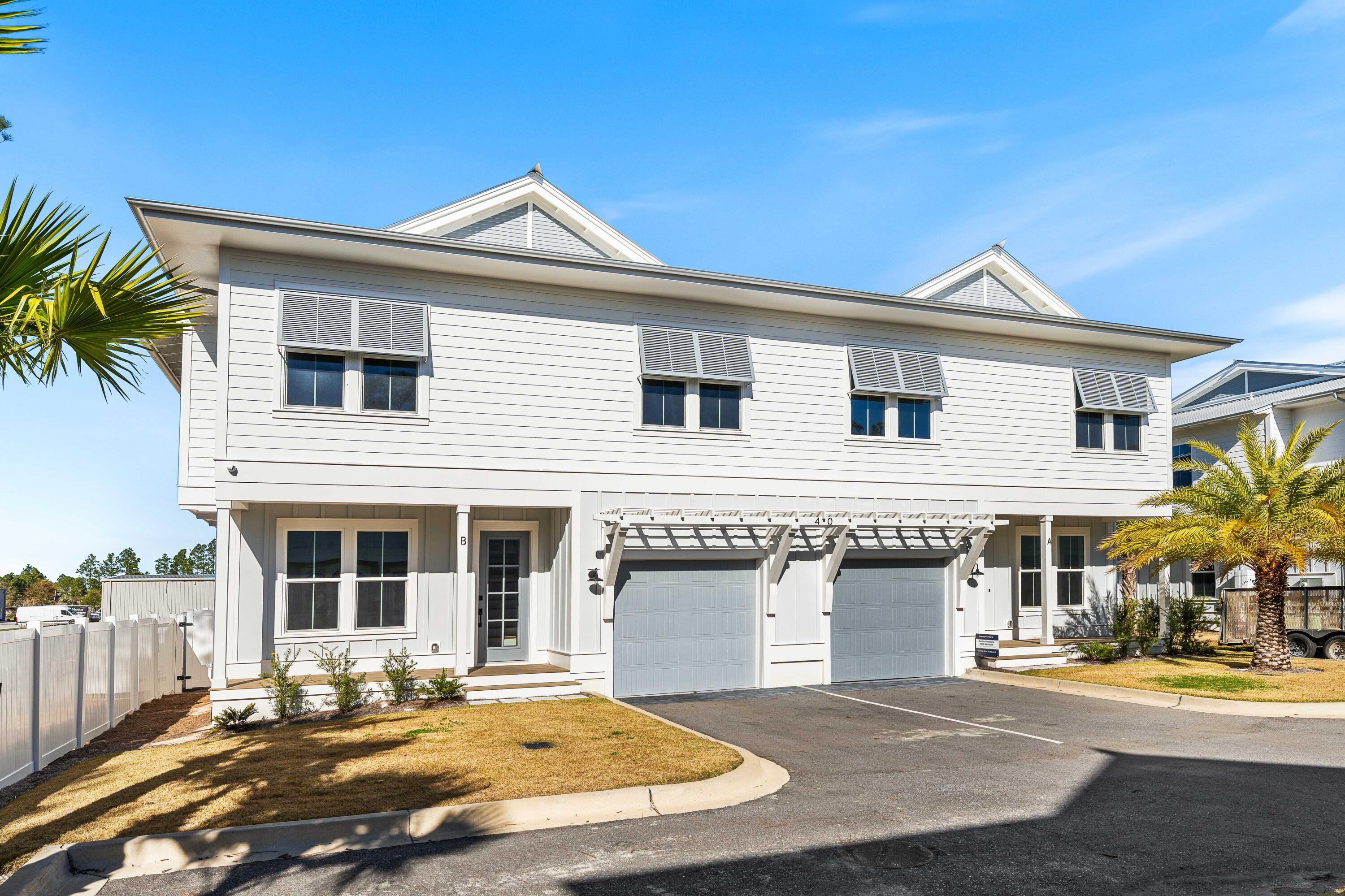 Welcome to Century 393, the newest and most exciting townhome development in Santa Rosa Beach, Florida. This exclusive community offers unparalleled access to 30A's best just a three-minute golf cart ride to Ed Walline Beach, Shunk Gulley, Papa Surf Burger Bar, and the lively Gulf Place town center. Unit #40B boasts 1,914 square feet of heated and cooled living space, with 2,412 square feet under roof. Designed for modern coastal living, this three-bedroom, four-and-a-half-bath townhome features a versatile bunk room, high-end finishes, an outdoor kitchen, and a fully fenced backyard making it an ideal personal retreat. The open-concept first floor seamlessly connects the living, dining, and kitchen areas, with ample natural light enhancing the coastal elegance. A walk-in pantry, laundry room, powder bath, and one-car garage complete the main level. Upstairs, the spacious primary suite boasts a dual vanity and walk-in shower, while both guest bedrooms each feature their own private ensuite baths. The additional bunk room offers flexibility as an office or extra sleeping area, complemented by a hall bath with a double vanity and tub/shower combo. Every home in this exclusive community enjoys an outdoor kitchen and a fenced backyard for private entertaining. A dedicated ice machine in the garage makes beach days effortless. This marks the first completed phase, with future expansion on an adjacent 10 acres set to introduce a stunning community pool, sun deck, and cabana. Don't miss your chance to rent in this premier up and coming development along 30A.