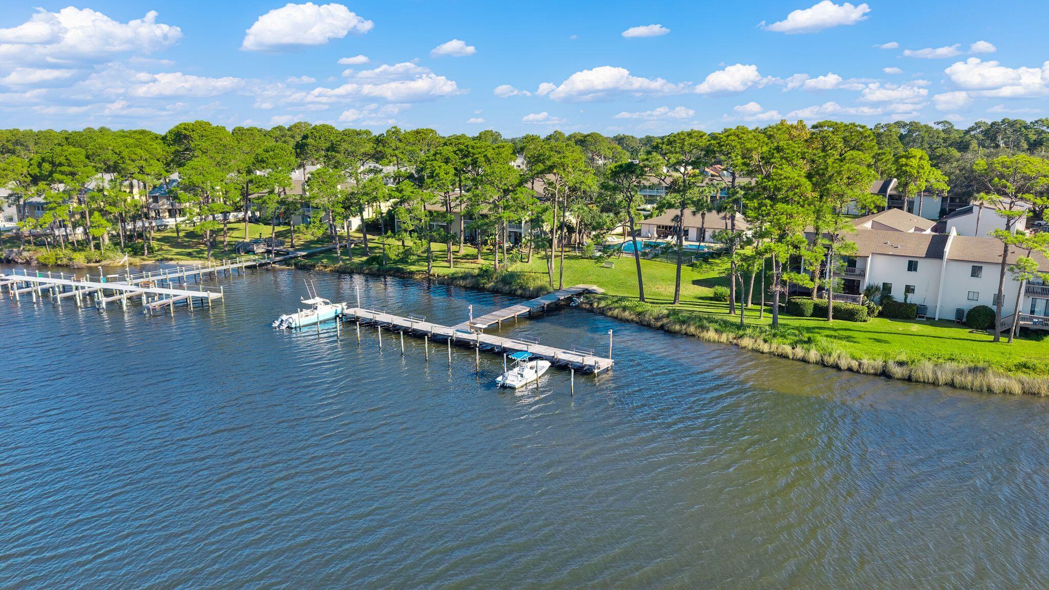 Life waterfront on Grand Lagoon is calling. This beautifully renovated, fully furnished, ground-floor condo is stunning. And with your boat never far away at the dock and the white sandy beach just a short drive down the road, this is an incredible second home or primary residence. 

This 2-bedroom, 2-bath home is truly move-in ready. Freshly renovated and furnishings included, start your mornings on the covered back patio with a cup of coffee before heading out on the water. The galley kitchen is bright and inviting, with white cabinets, stainless appliances and a decorative tiled backsplash. Gather for dinner and settle into the spacious living room after a long day of sun and salt air after being at the pool. Ground-floor living means no hauling beach gear, groceries, or fishing tackle up the stairs! 

Both bedrooms are generously sized with plenty of closet space, so there's room for guests to settle in comfortably. Both baths have been fully renovated with new tiled showers, new vanities, and new toilets. A full size washer and dryer are also included in the unit making it a great place to stay for long trips. With water views, furnishings included, this condo needs nothing but you! 

The best part waits just outside your door. Palisades offers a waterfront boat dock and fish cleaning station right on Grand Lagoon. Dock your boat, and you're a short cruise from Shell Island's crystal-clear shallows or the open Gulf for a day of fishing. Come back in with the catch of the day and clean it right on site. If fishing isn't your thing, grab a paddleboard or kayak and explore the calm waters of the lagoon, or head a few minutes to the World's Most Beautiful Beaches. 

In between adventures, cool off in the community pool, community pool play a match on the community tennis courts. Boat slips are first come, first served and you may leave your boat in the water as long as you'd like. 

Like to keep your boat in dry storage at Pirates Cove or Treasure Island just down the road? This is perfect to take your boat out of storage and keep it behind your own condo whenever you want! 

Some of Panama City Beach's most popular restaurants and waterfront hangouts are just minutes away, so sunset dinners and live music are always close by. Whether you're looking for a full-time home, a weekend escape, or a place to make your beach-life dreams come true, Unit 37 has it all. 

HOA fees include water, sewer, garbage, exterior insurance, community room, dock, pool, tennis, groundskeeping and cable.