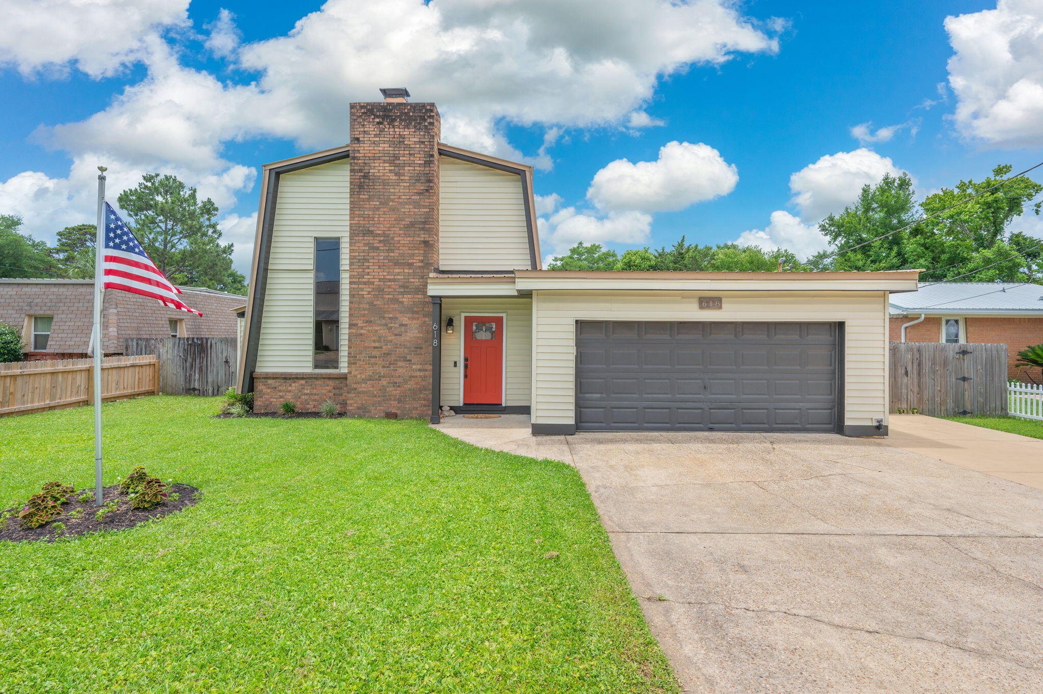 Come see this beautiful, updated, and unique home in the heart of Fort Walton Beach!  Upon entering the home you'll love  the wood-look ceramic tile, wood-burning fireplace and cathedral ceilings leading up to a stunning wrought iron staircase. Dine and entertain in the large, open, light and bright kitchen with Island containing plenty of cabinets for storage plus a pantry. Enjoy your peaceful, fully-fenced backyard with a patio, shed, and well-fed sprinkler system. The thoughtful floorplan includes a pirmary/master bedroom with ensuite tucked away on the main floor with the additional bedrooms upstairs for extra privacy.  So many lovely details in this home. Schedule your showing today!