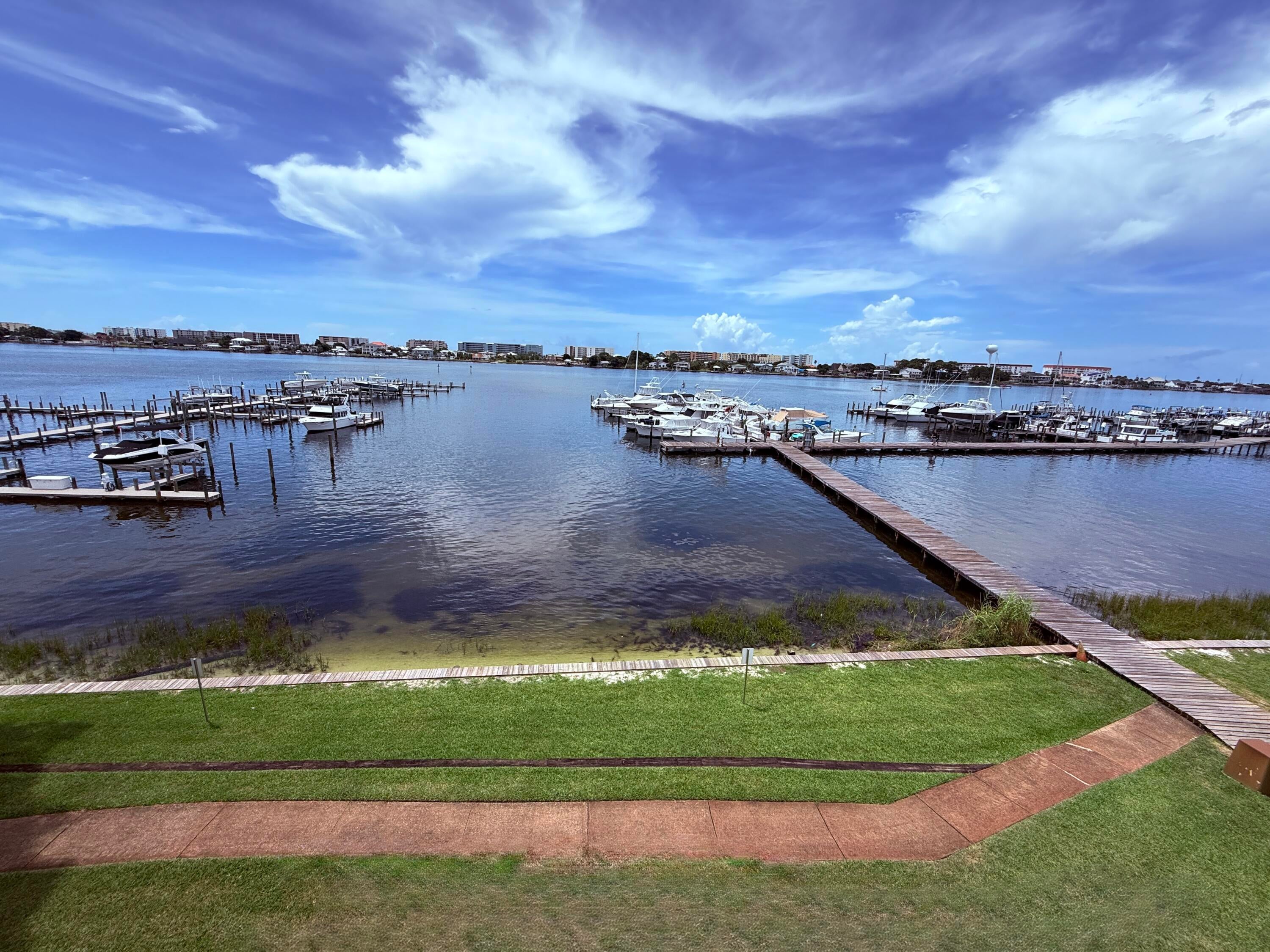 A RARE WATERFRONT OPPORTUNITY AT PIRATES BAY! This UPDATED 3rd-floor, 585sf END UNIT includes an impressive 54' BOAT SLIP with 17' BEAM and features a spacious WRAP-AROUND BALCONY with spectacular WATER VIEWS!  Multiple sliding glass doors and windows fill the condo with natural light and showcase beautiful views overlooking the Intracoastal Waterway, Okaloosa Island and toward the Gulf. Unlike many condo units, this one offers a FULL KITCHEN featuring Quality Wood Cabinets, Updated Countertops and a Large Center Island with storage!  The spacious Primary Suit opens to the balcony and features TWO VANITIES, providing additional storage and functionality. A FULL-SIZE WASHER AND DRYER adds comfort and convenience. Pirates Bay offers well-maintained waterfront grounds with ELEVATORS, TWO LARGE SWIMMING POOLS, PICNIC AND GRILLING AREAS, AND A BEAUTIFUL MARINA. With its desirable END-UNIT location, wrap-around balcony, incredible waterfront views and exceptionally large 54' x 17' BOAT SLIP.  Condo Association Fee includes Water, Sewer, Trash, High speed Wifi, Cable Plus with HBO Max on demand.  Occupy full time or, visit occasionally and rent it short-term when you are away! This is a RARE opportunity to own your own, premier unit at Pirates Bay!