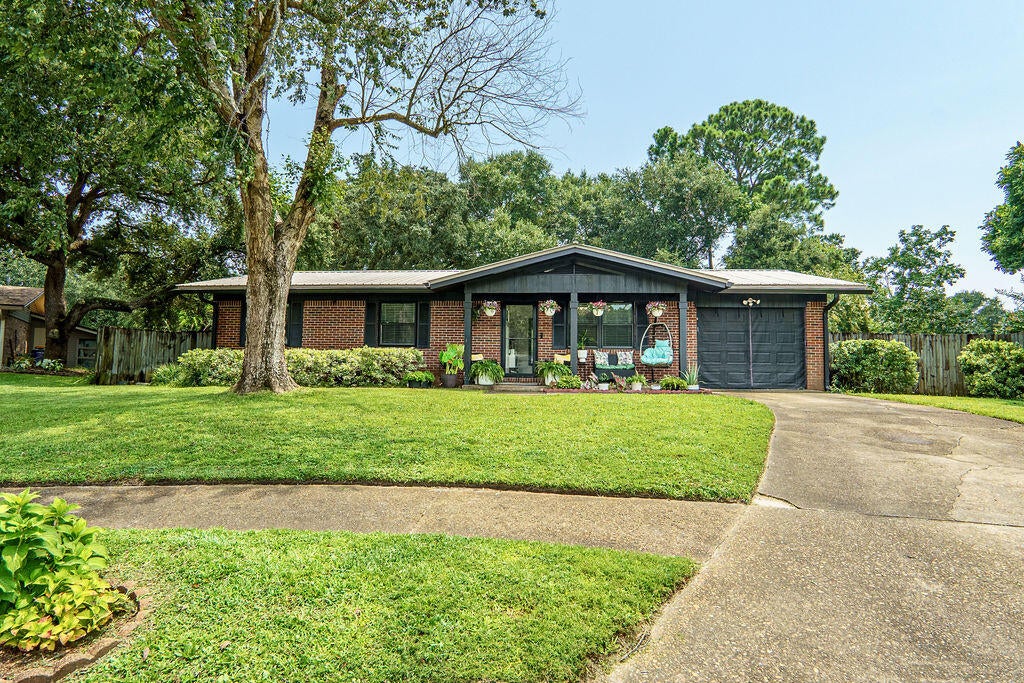 This 3 bdrm/2 bath home has been meticulously maintained and is ready for a new homeowner to join in the Christmas Holidays.  The neighborhood is known for their annual luminary display and decorations.  The kitchen has granite countertops and new backsplash with loads of storage.  The garage can be converted back to a 1 car garage but is currently being used as a gym - all equipment remains. There is no carpet in the home. Out back is an enormous screened in patio with a hot tub, and the patio furniture remains. You will love the neighbors, too. Come see this adorable home and make it yours!