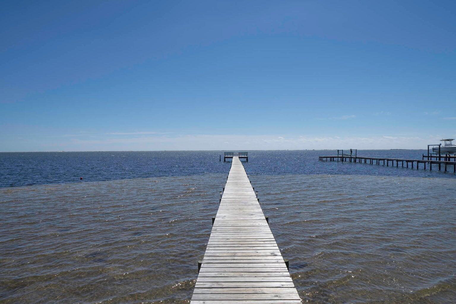 Imagine waking up to breathtaking views in Smugglers Cove, an exclusive waterfront community along the pristine Santa Rosa Sound. This prime corner lot is thoughtfully positioned to provide both peaceful seclusion and effortless access to the water, backing up to a tranquil pond—a perfect retreat for relaxation. Whether you're launching your boat from the private community ramp, enjoying a quiet afternoon of fishing from the dock, or cruising in the Sound at sunset, this location offers unparalleled coastal living. Indulge in resort-style amenities, including a pool and tennis courts, all while benefiting from an exceptionally low HOA. Best of all, this property sits in an X flood zone, meaning no flood insurance is required, giving you significant long-term savings and peace of mind.