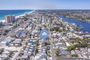 'CURRENTLY UNDER CONTRACT, SELLER WILL CONSIDER BACKUP OFFERS INVESTORS SPECIAL - BRING OFFERS!!! Just a short walk to the Gulf and minutes from Grand Lagoon boating access -- all of this with no HOA or HOA fees. Located in the desirable Holiday Beach area, this charming 2-story, 2-bedroom, 1-bath beach cottage offers approximately 1,056 sq ft and is perfectly positioned for beach lovers, boaters, and vacation rental investors. Recent updates include a roof approximately 8 years old, brand new septic tank, AC system approximately 10 years old with a new motor, tankless water heater installed in 2018, and an updated kitchen with stainless steel appliances. The washer and dryer are included, providing added convenience for homeowners or rental guests. The property does need some cosmetic updates, deck repairs, and yard manicuring, making it a fun project for a first-time home buyer or investor looking to add value and even more curb appeal. Effective year built is 2013. Holiday Beach is known for its close proximity to the Gulf and Grand Lagoon, making it a highly desirable area for vacation rentals, boating, and beachside living. Whether you're a beach enthusiast, boater, investor, or first-time buyer, this property offers the opportunity to create your own coastal retreat or income-producing beach property.