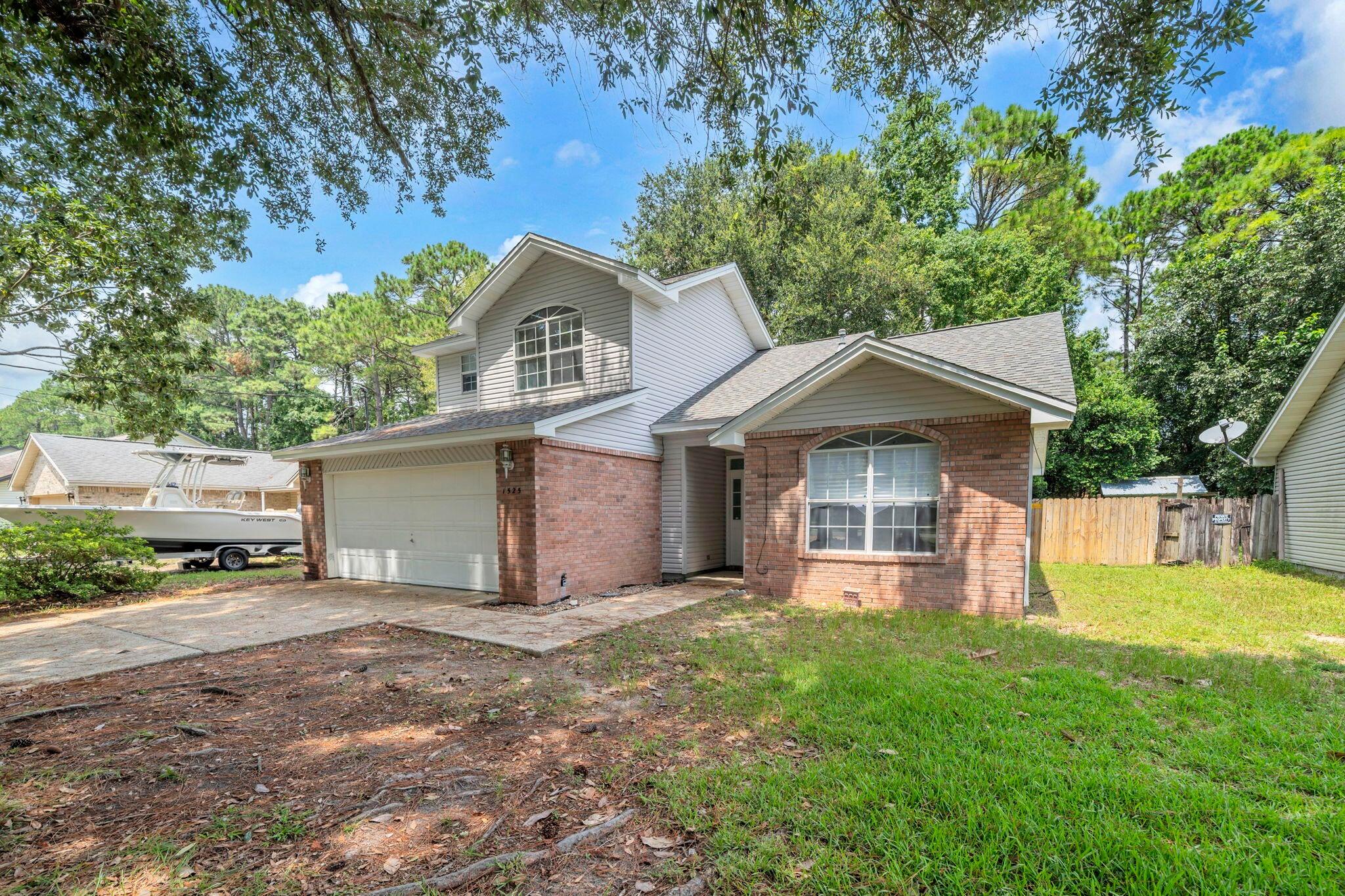 Welcome home to your MOVE IN READY home in south Niceville, convenient to everything! This home features A 2-car garage and an open floorplan with 2 bedrooms and a full bath on the first level and a private master suite on the second level. Entering this home through the foyer, you will see that the family room has a vaulted ceiling making this space light and bright. Open to the family room is the tiled dining area with sliding glass doors leading to the covered patio.  The kitchen adjacent to the dining area is nicely appointed with a gas stove, oven and refrigerator and just off of the kitchen you will find the laundry area. The downstairs bedrooms are a generous size and the upstairs master bedroom offers plenty of space for large furniture. The huge fenced back yard is perfect for both kids and pets. The interior of the home has just been painted and the carpet is new so all you have to do is move in! WELCOME HOME!!