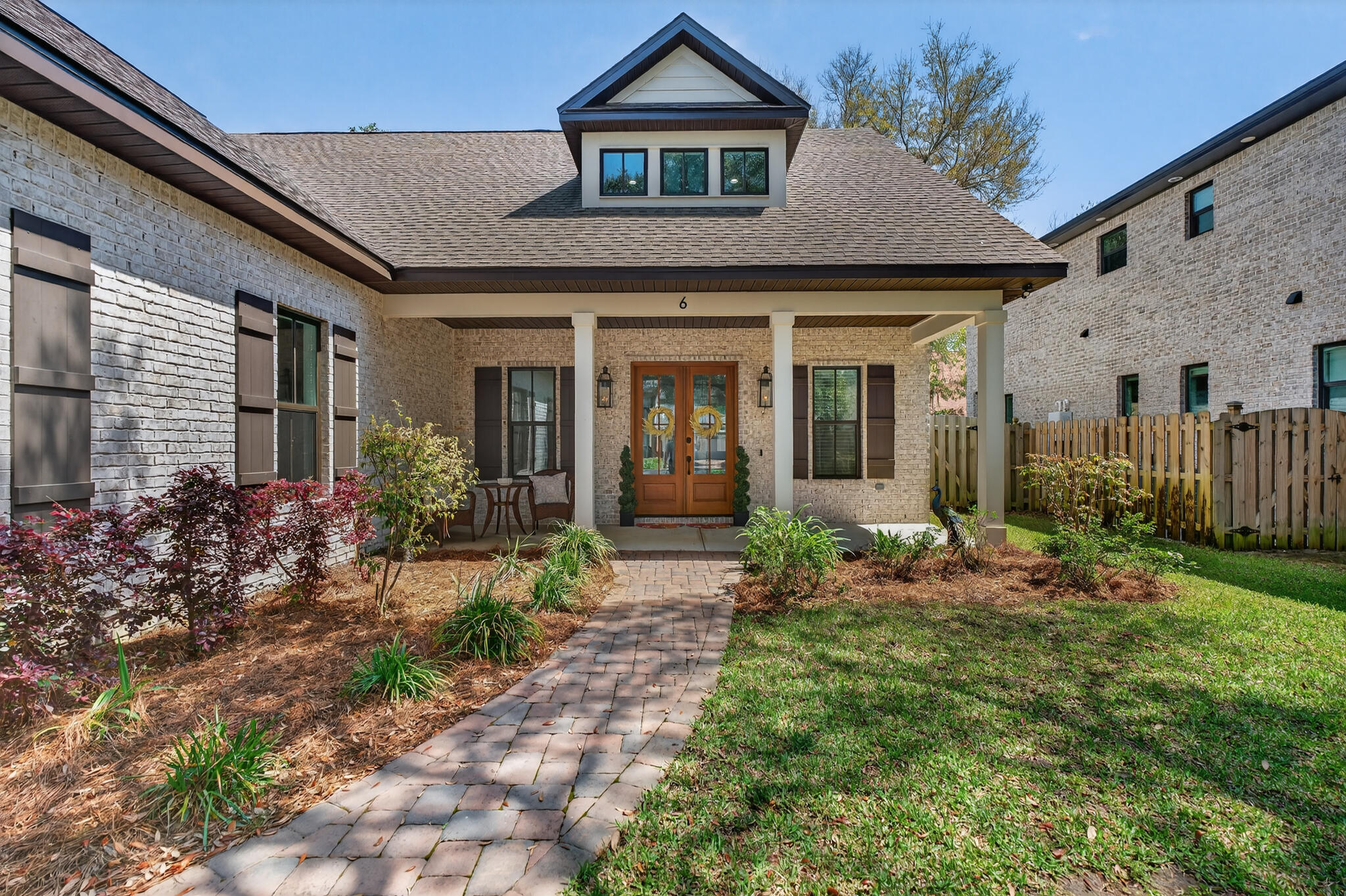 Built in 2021 by renowned local builder Damian Curtis, this 2,649-square-foot home with 4 bedroom + office and 2.5 baths blends timeless Southern charm with modern comfort. Ideally located on a gorgeous oak tree lined street and surrounded by all newly built homes. This home offers easy access to Hurlburt Field and Eglin Air Force Base, and just minutes from the sugar-white sands of Okaloosa Island, it offers the perfect balance of convenience and coastal living. Evenings can be spent by the water, toes in the sand, watching breathtaking sunsets over the Santa Rosa Sound--an everyday reminder of what makes this area so special.

Nestled on a quiet cul-de-sac in Plantation Oaks beneath a canopy of mature live oaks, the home was designed with both elegance and livability in mind. The open-concept living and dining areas create a natural gathering space for entertaining or simply enjoying everyday moments. A striking oversized gas fireplace with a shiplap surround and custom built-in shelving draws the eye upward to 10-foot ceilings, setting the tone for the home's refined yet comfortable style.

The chef's kitchen is both elegant and functional, filled with natural light and featuring crisp white shaker-style cabinetry, brushed metal hardware, under-cabinet lighting, and light quartz countertops. A gas cooktop with a convenient pot filler makes meal prep effortless, while the marble and glass mosaic backsplash--designed in a geometric floral pattern with soft whites and grays--adds texture and timeless sophistication.

Just off the main living area, the private first-floor primary suite offers a peaceful retreat. The spa-like ensuite includes a soaking tub, glass-enclosed walk-in shower, dual vanities, a private water closet, and generous walk-in closets.
A thoughtfully designed laundry and mudroom off the oversized garage creates an ideal transition space for daily life, blending practicality with organization.
Upstairs, three spacious bedrooms, a full bath, and a versatile office or flex space overlooking the front of the home provide room to grow, work, and relax. Additional walk-in attic storage with flooring makes staying organized simple and convenient. You could also finish the attic room into more living space such as another bedroom, cinema room, craft room or play room and it would add another approximately 800 square feet of living space. 

Residents of Plantation Oaks enjoy access to a neighborhood walkway easement leading to the Intracoastal Waterway, where the beauty of the Santa Rosa Sound invites you to unwind, explore, and experience the very best of Emerald Coast living.