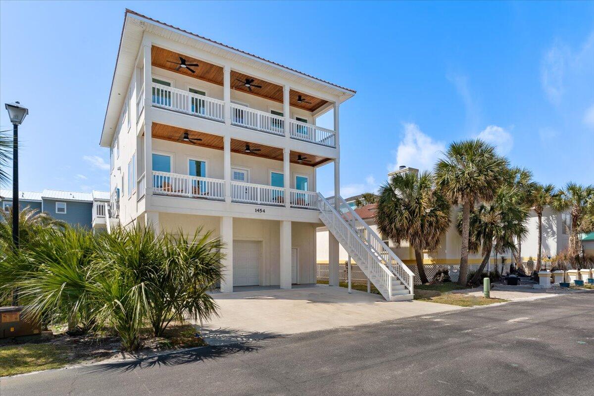 This 5-bedroom, 5-bath home offers luxury and convenience, featuring two ensuite master bedrooms and a three-stop elevator for easy access on all levels. Built on helical pilings to withstand 180mph hurricane winds, it's designed for ultimate durability. The office/bunk room can also serve as a game room, adding extra versatility. Located in a short-term rental-friendly community with access to a private beach on the sound, boat dock, and community pool, it's close to public beaches, restaurants, shops, and the bridge. Perfect for coastal living or investment!