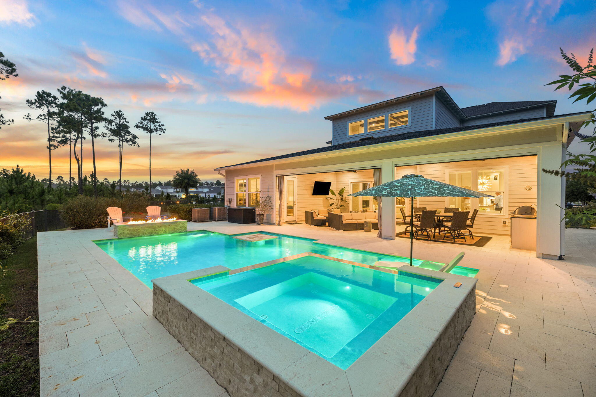 Welcome to 67 Tamoka Court, an exceptional four-bedroom Venice floor plan offering refined design, extensive upgrades, and a remarkably private outdoor setting in NatureWalk at Watersound Origins. Backing directly to a peaceful nature preserve, the homesite also provides valuable yard space on both sides. Its location and thoughtful landscaping create an outdoor retreat that feels exceptionally secluded.

Inside, the dramatic two-story great room is highlighted by architectural ceiling beams and a gas fireplace framed by designer tile extending from floor to ceiling. Expansive five-panel doors open the living area to an extended covered lanai, creating a seamless connection between the home's indoor and outdoor entertaining spaces.

The private backyard centers around a custom 469-square-foot saltwater pool with gas heat, a tanning shelf, built-in table and seating area, multicolored LED lighting, and smartphone-enabled controls. An elevated 64-square-foot spillover spa features eight jets, while an impressive fire-and-water feature adds ambience with a linear flame and cascading waterfall. Shellstone pavers surround the pool and covered lanai, and a fully equipped outdoor kitchen includes a built-in grill, refrigerator, granite countertops, sink, and natural gas service.

The gourmet kitchen is equally impressive, featuring Level 4 cabinetry, stacked upper cabinets, Level 4 quartz countertops, a Level 5 natural-stone backsplash, a GE Café 36-inch gas cooktop, (continued) and a built-in 48-inch refrigerator. A farmhouse-style sink, under-cabinet lighting, generous storage, and thoughtfully selected finishes complete this highly functional space.

The main-floor primary suite offers direct access to the covered lanai and a spa-inspired bath with upgraded tile, quartz countertops, four body sprays, a custom makeup vanity, and additional built-in storage. A private home office, spacious laundry room with cabinetry and a dedicated dog-wash station, and a golf-cart garage further distinguish this customized Venice plan. 
Upstairs, three additional bedrooms and an open loft-style living area provide comfortable and flexible accommodations for family and guests. RevWood engineered flooring extends through the main living areas, office, loft, and bedrooms. Additional upgrades include custom lighting and chandeliers, wire stair railing, stained stair treads, extensive crown molding, built-ins, plantation shutters, and raised television and dimmer packages.

Ideally located near the community's exceptional amenities, top-rated schools, Publix, local dining, and the beaches of 30A, 67 Tamoka Court offers the privacy, designer finishes, and resort-style outdoor living buyers seek in NatureWalk. Schedule your private showing and experience this beautifully customized home and its extraordinary outdoor retreat.