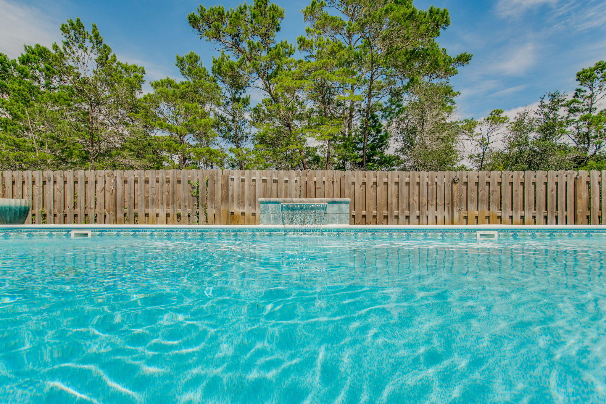 LOW INTEREST RATE!! SELLERS WILL CONSIDER NON VA BUYER!!
Welcome to this charming POOL home in the heart of Gulf Breeze, Florida. This delightful 4-bedroom, 3-bathroom house offers a spacious 2,304 square feet of living space, perfect for families or those who love to entertain. As you step inside, you'll be greeted by an open floor plan that seamlessly blends comfort with style. The luxury vinyl plank flooring and shiplap walls add a touch of coastal flair, while the enclosed office with a sliding barn door and closet provides a quiet space for work or study. The kitchen is a culinary enthusiast's dream, boasting granite countertops, crisp white cabinets, and gleaming stainless steel appliances. Whether you're whipping up a quick breakfast in the cozy nook or preparing a gourmet meal at the island, this kitchen has you covered.
The primary bedroom is a true retreat, featuring an ensuite bath with a double vanity, walk-in closet with custom shelving, stand-up shower, and a garden tub that's practically begging for a bubble bath and a glass of wine. 
Outside, the inground saltwater pool is perfect for those hot Florida days. The fenced-in yard provides privacy and peace of mind, while the exterior Hardie board siding offers durability and low maintenance. And for all you car enthusiasts (or just those with a lot of stuff), there's a spacious 3-car garage. There is also a sprinkler system and well to make yard maintenance a breeze!!

Located just a short distance from local attractions, you'll find the Lighthouse Private Christian Academy, Soundside Public Beach, and the Gulf Breeze Zoo nearby. Imagine spending your weekends alternating between beach days and animal adventures!
This home isn't just about looks - it's practical too. With a termite bond in place, you can rest easy knowing your investment is protected. And let's not forget the charming front porch - the perfect spot for sipping sweet tea and waving to neighbors.