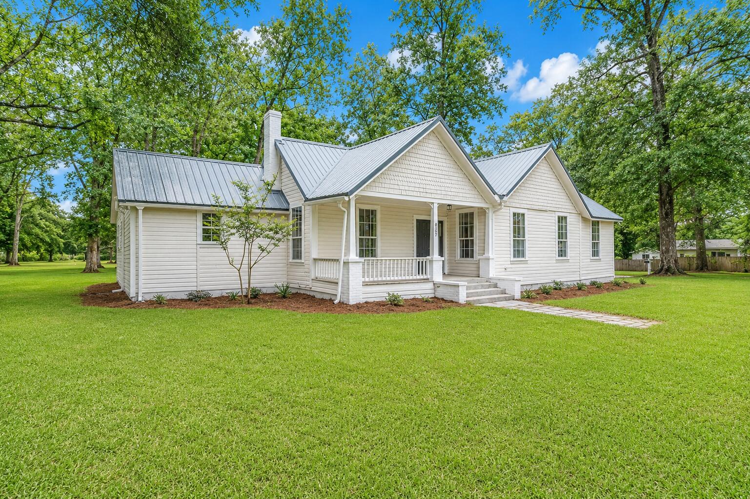 A piece of LAUREL HILL HISTORY is officially on the market, and this one is NEWLY RENOVATED... OFFERS A SMALL PECAN ORCHARD... and is AROUND THE CORNER FROM THE BELOVED SCHOOL!

Welcome to the Doc Stephens House, circa 1950! This single-story 4 BR/3 bath victorian offers REFURBISHED ORIGINAL HARDWOOD FLOORING... original moldings, casings and trim.. with an UPDATED GOURMET KITCHEN that is well-suited for your bed and breakfast dreams! 

The kitchen features ceiling-height cabinetry with soft-close features, premium quartz counters and quartz island, subway tile backsplash and farm sink with gold plated faucet and fixtures. 

There is a large eat-in kitchen, as well as a FORMAL DINING ROOM PERFECT FOR ENTERTAINING. 

The laundry room is a showstopper with bricked flooring, added cabinetry and a newly transformed half bath, inspired by 1950's design. 

There are several aesthetic fireplaces found throughout the home... adding historic charm (decorative only). One of them can be found in the gathering room.

The living/gathering room... which is EXTREMELY LARGE... boasts original hardwood floors and a wall of picture windows that flood the space with light. 

There are 4 bedrooms in Doc Stephens House, and one of them was recently transformed (master suite).

The master suite offers a spacious walk-in closet, hardwood flooring and an en suite with custom tiled shower and frameless glass enclosure. The quartz vanity offers 2 sinks, soft-close features 

(continued) and a linen tower. 

The 3 remaining bedrooms are all indicative of a historic home... with wood flooring and beautiful moldings. Two of the guest rooms offer a fireplace, and 1 of them will require an armoire (missing closet). 

The acreage is gorgeous (1.05 AC)... with 3 inviting porches to enjoy views of mature pecan trees and the country vibe. Newly added privacy fencing is a bonus. 

The metal roof is higher quality, but the age remains a mystery. Buyer to do their due diligence. The HVAC was installed in 2017. 

The home is priced below market value for a quick sale! Better hurry.