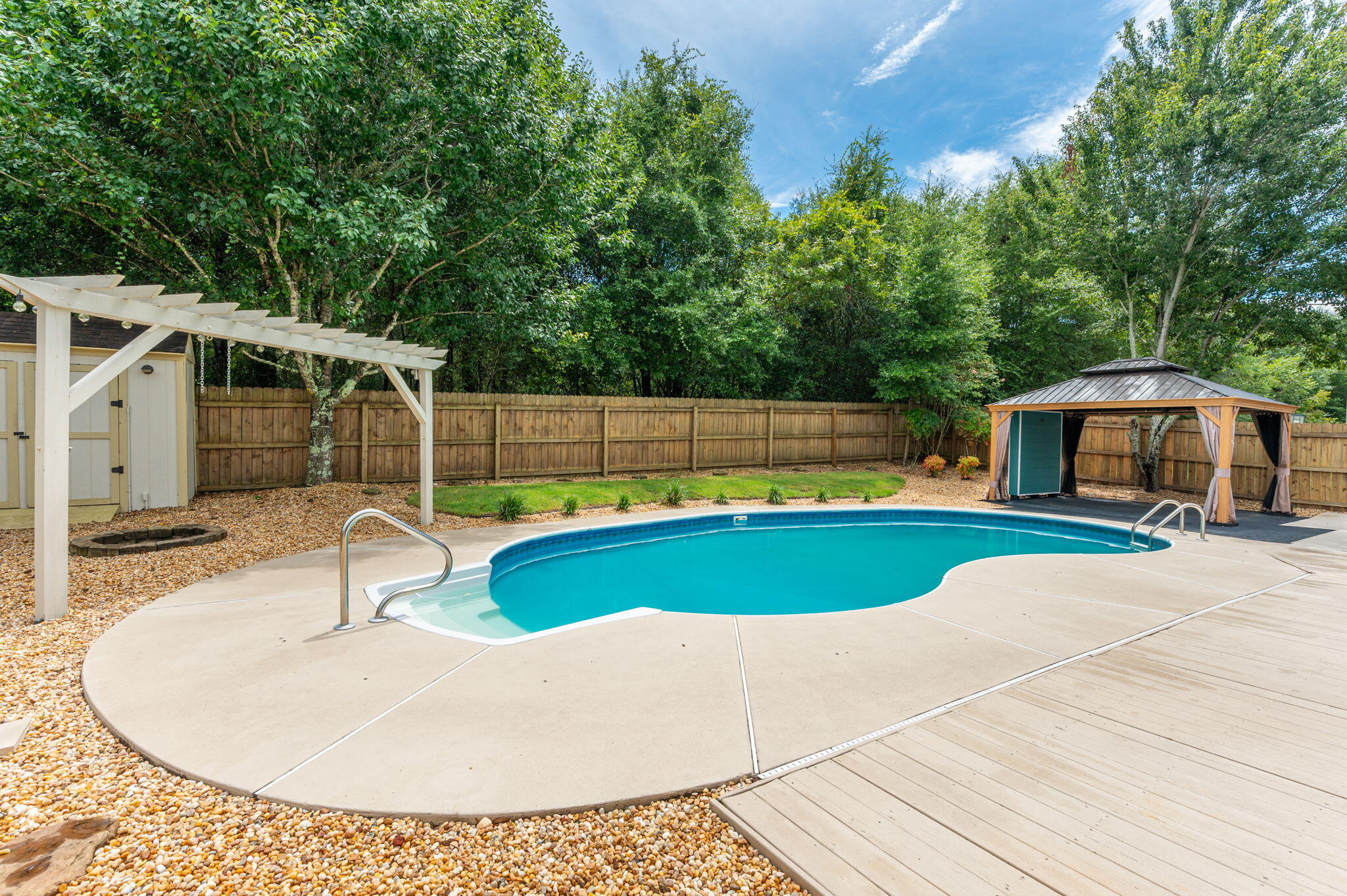 Welcome home to this beautifully maintained all-brick 4BR/2BA pool home in the desirable Iron Gate community of South Crestview--NO HOA! Situated on a quiet cul-de-sac, this 2,165 SF split floor plan features a dedicated office, formal dining room, spacious living area, and an updated kitchen with granite countertops, stainless steel appliances, refinished cabinets, and pantry. The primary suite offers French doors to the covered patio, double vanities, soaking tub, walk-in shower, and two walk-in closets with custom shelving.  Step outside to your private backyard oasis with an in-ground pool, Gazebo with lights, GFI & fan, covered patio, hot tub (conveys), and storage shed. Major updates include a 2020 roof, 2017 HVAC with air purifier, and 2013 water heater. Conveniently located near military bases, shopping, and schools, this move-in ready home offers the perfect blend of comfort, style, and Florida outdoor living!