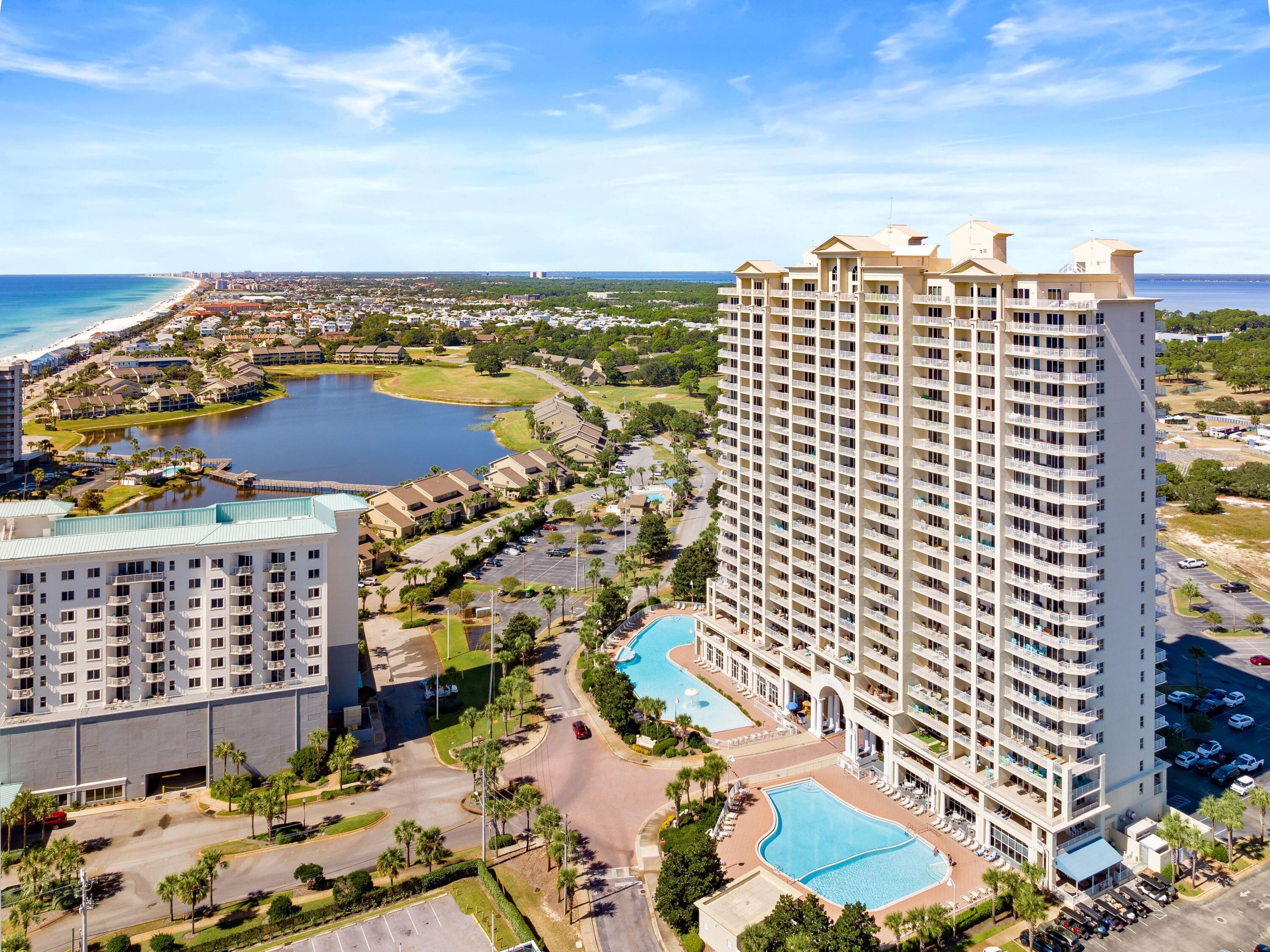 Perched on the 15th floor of Ariel Dunes I, this beautifully furnished two-bedroom, two-bath condominium captures some of the most expansive water views in the area, offering sweeping panoramas of both the Gulf of America and Choctawhatchee Bay. Positioned high above neighboring buildings, the residence enjoys a unique vantage point that allows uninterrupted views over Majestic Sun, creating a striking coastal backdrop from sunrise to sunset.  

Inside this freshly painted unit, the thoughtfully arranged floor plan comfortably accommodates up to six guests and blends everyday comfort with vacation-ready style. The primary suite features a king bed, private ensuite bathroom, and direct access to the balcony, where the sound of the surf and wide-open gulf views become part of the daily routine. A queen bedroom and an additional full bath provide welcoming accommodations for guests, while the spacious living area offers plenty of room to unwind after a day at the beach. The fully equipped kitchen featuring brand new stainless steel appliances and the dedicated laundry room add convenience for extended stays or rental guests.

Step outside onto the private balcony and take in the sweeping coastal scenery that defines life along the Emerald Coast. Whether enjoying morning coffee as the sun rises over the water or relaxing in the evening as the sky turns shades of pink and gold, this elevated perspective is one of the property's most memorable features.

This residence has also proven to be a strong income-producing investment, currently operating as a short-term rental with professional management and generating approximately $27,000 annually. The property conveys fully furnished, including balcony furnishings, making it ready for immediate enjoyment or continued rental use.

Residents enjoy access to the extensive amenities of the Seascape resort community, including private deeded beach access, a championship golf course, on-site dining, and convenient shopping within the resort grounds. Ariel Dunes I itself offers resort-style amenities, including a large zero-entry pool, fitness center, and beautifully maintained grounds, enhancing the coastal lifestyle.

Beyond the resort, Miramar Beach places you within minutes of some of the Emerald Coast's most popular destinations. Silver Sands Premium Outlets offers more than 100 designer stores and dining options nearby, while beachfront favorites like Whale's Tail and Pompano Joe's are within easy reach. The nearby Village of Baytowne Wharf and Grand Boulevard add even more entertainment, restaurants, and shopping just a short drive away.