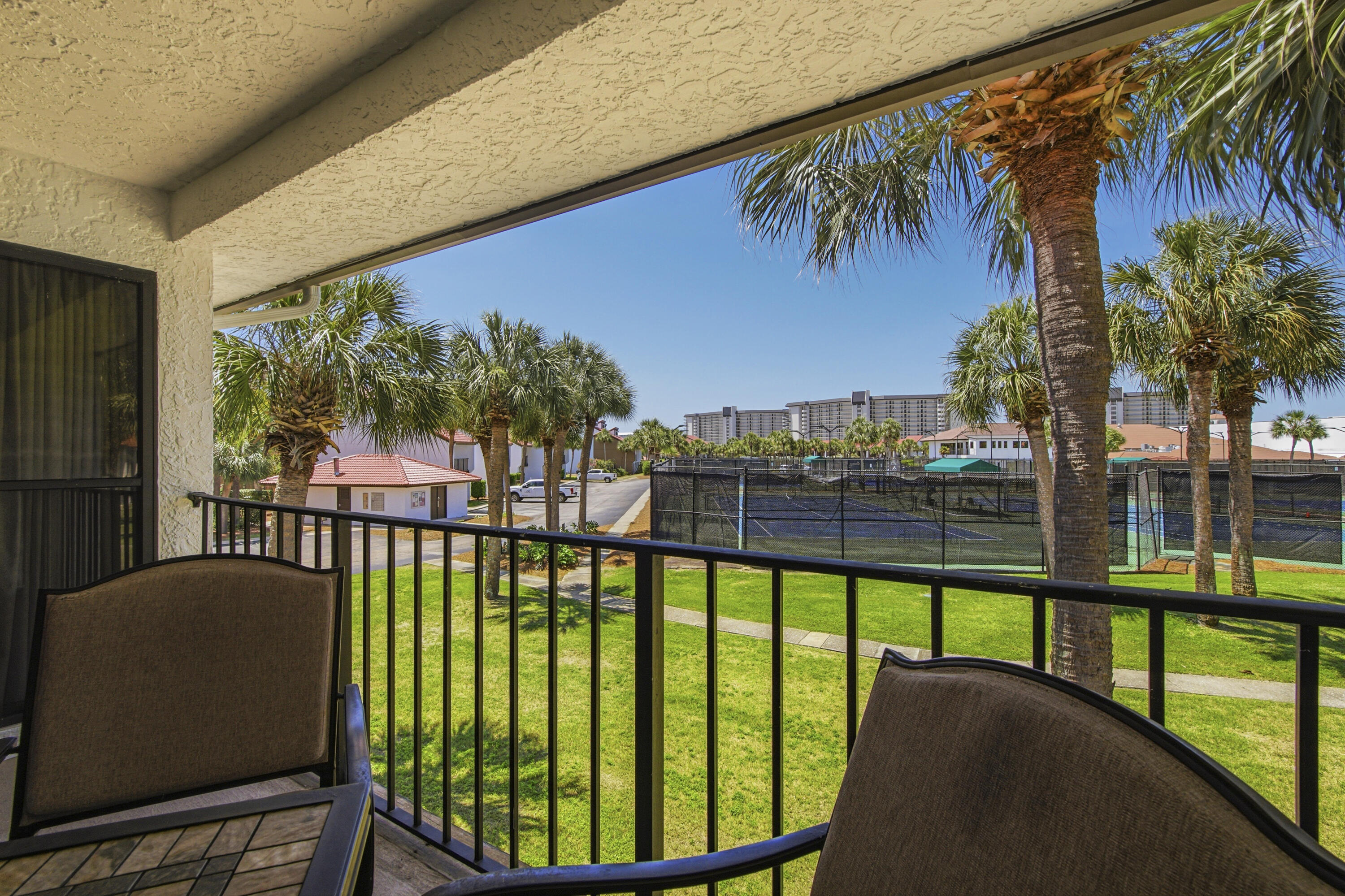 9 Hole Par 3 Golf Included! Your slice of coastal paradise awaits in the sought-after River Oaks phase of Edgewater Beach & Golf Resort! Perfectly positioned for sports enthusiasts, this fully furnished 2-bedroom, 2-bathroom villa boasts over 1,200 square feet of airy, light-filled living space directly overlooking the resort's tennis courts. The updated kitchen is a standout feature, beautifully equipped with modern countertops, cabinetry, appliances, and a large breakfast bar that flows seamlessly into the great room. Floor-to-ceiling windows flood the living area with natural light, leading out to a private back porch, the perfect spot to unwind after a day on the courts or the sand. Turnkey & Fully Furnished: Ready to go with updated living room furniture. Major Mechanical Peace of Mind: Complete HVAC replacement in 2023. Prime Location: Just steps from the tennis center, community pool, and the 9-hole, par-3 golf course. Edgewater is Panama City Beach's premier full-service resort. Take the pedestrian walkway safely over to the sugar-white sands and world-class Gulf sunsets, or enjoy an unparalleled amenity package: a massive lagoon pool, multiple heated pools, hot tubs, a kid's splash pad, pickleball, basketball, shuffleboard, a fitness center, an on-site restaurant, and 24-hour gated security. Located just minutes from Pier Park and the area's best dining, this exceptional villa is a turnkey second home or a lucrative investment opportunity. Schedule your private tour today!