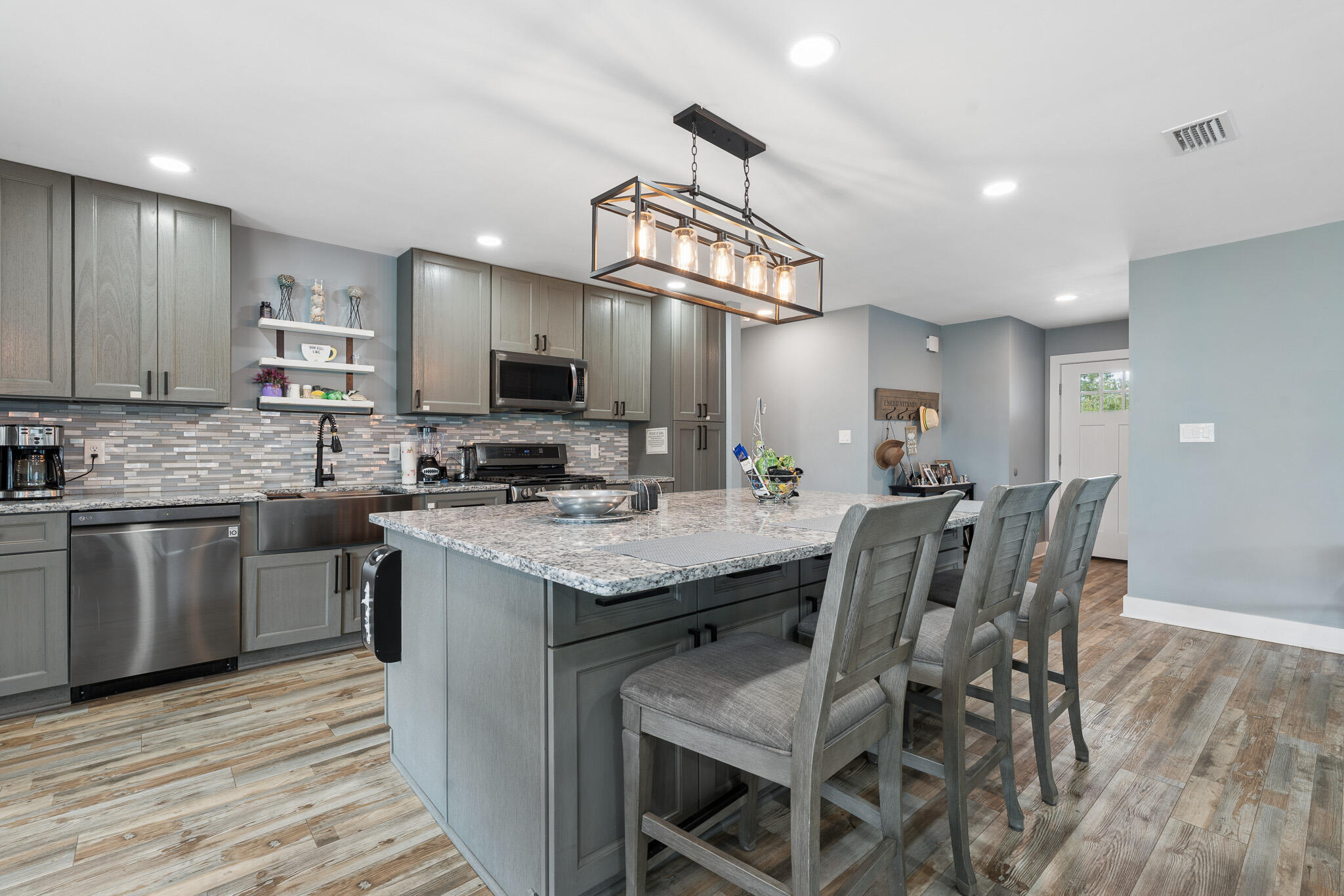 Motivated Seller!  $5K toward Buyers closing costs!  This beautifully updated like-new home in Callaway offers modern comfort, thoughtful upgrades, and convenient access to everything the area has to offer. Located just minutes from shopping, restaurants, and waterfront recreation, enjoy being approximately 0.4 miles from fishing charters at Pier 98, 1.4 miles to a public boat ramp, 4 miles to Tyndall Air Force Base, and about 33 miles to St. Andrews State Park. Extensively remodeled and brought down to the studs following the hurricane, this home features updated electrical, plumbing, and gas lines for added peace of mind. Designed with efficiency and comfort in mind, upgrades include a tankless gas water heater, whole-house generator, solar panels that will be paid off at closing, impact-resistant windows, and automatic shades. The kitchen is a standout with stainless steel appliances, gas range, quartz countertops, decorative glass backsplash, and an oversized island with ample space for entertaining, gathering, or game nights. Interior finishes include recessed lighting, updated fixtures, and luxury vinyl plank flooring throughout. The spacious primary suite features dual closets and a spa-inspired bath complete with an open walk-in shower, jetted soaking tub, Bluetooth speaker, and smart lighting features. The guest bath has also been tastefully updated with a glass tub enclosure, quartz countertop, and decorative sink. Transferable termite bond with Terminix! Exterior improvements include durable Hardie board siding and a durable standing-seam metal roof with an expected lifespan of up to 50 years, providing long-term value and potential insurance benefits.  All roof boots resealed in 2025.  Step outside to enjoy the covered patio and fully privacy-fenced backyard. A 12x20 site-built shed with insulation, electricity, and its own covered patio provides excellent flexibility for hobbies, storage, or workspace. The backyard is enhanced with fruit trees, a fire pit area, and an additional exterior outlet ready for future outdoor additions such as a hot tub. Don't miss your opportunity to own this extensively upgraded home with modern conveniences and room to enjoy both indoors and out. Buyer to independently verify all information, measurements, dimensions, restrictions, and any matters deemed important.