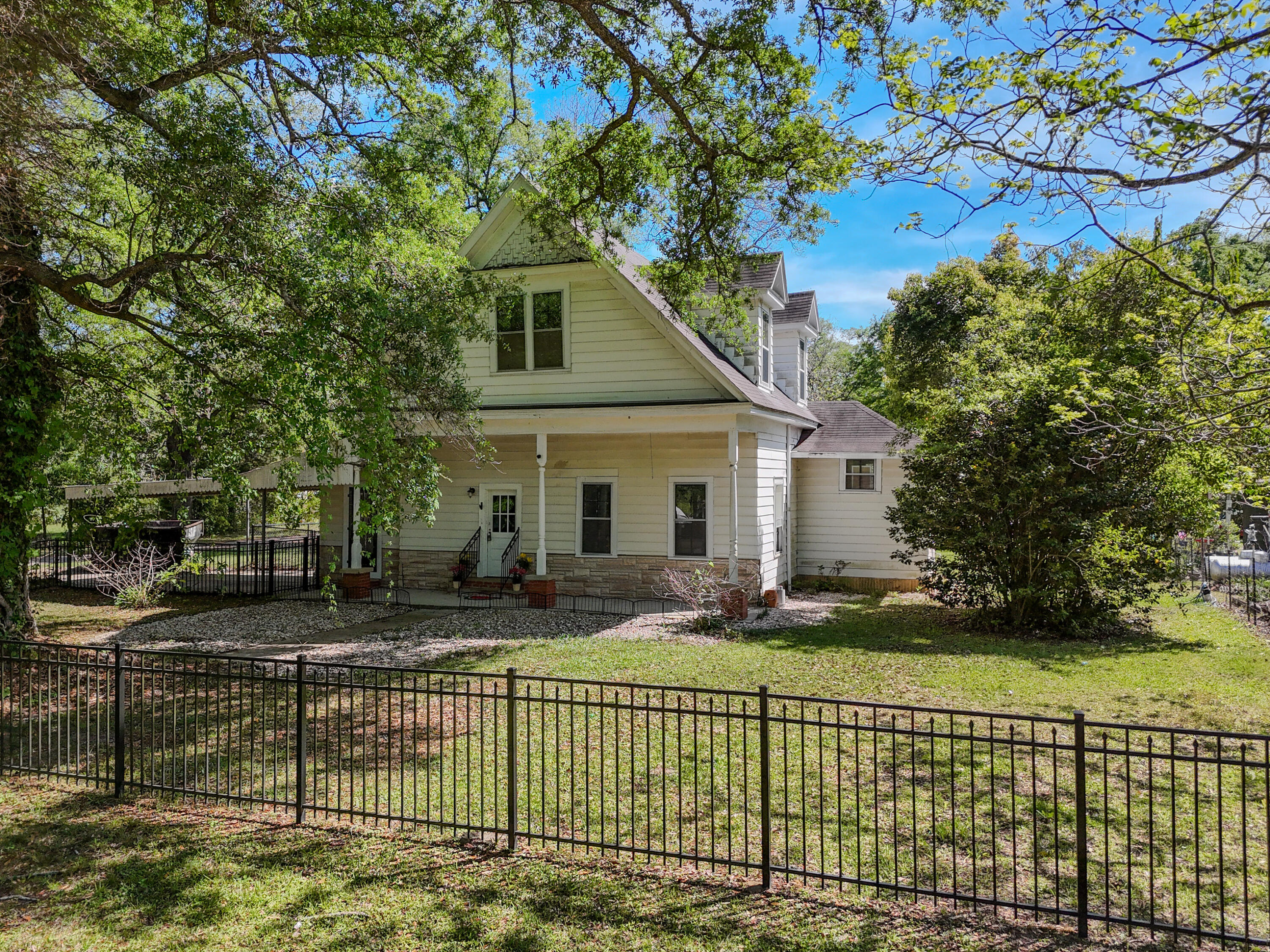 Classic 1910 2 story charming 3/1 house on a generous shaded corner lot with a large fenced-in yard, perfect for outdoor activities with the family, or just enjoying the peace and quiet. Home features a brand-new tankless water heater, new HVAC, new mini-split units upstairs. Has new gas lines under house, and the roof is less than 10 years old. Portion of the house has tongue and groove walls, other are paneling. French doors and all the charm are still in place. Home welcomes you with custom fence, covering trees and large covered porch great for afternoon relaxing. Attached carport, lots of flowering shrubs to enjoy plus Elliott pecan trees. 1 block over from town playground and park, located near beautiful Lake Jackson and Florala HS as well as Elementary school. Home is full of charm! Home sold as is - Cash or conventional only.