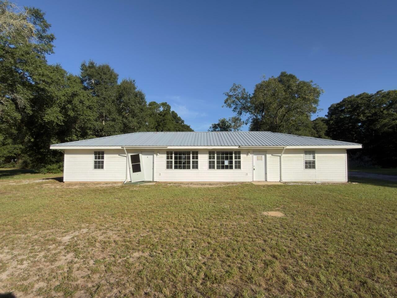 These REO opportunities do not happen often. This duplex was originally built in 2003. A total of 1664sf for both unitis, unit A and B are mirrors of each other. Each unit is 832sf with a living room, eat in kitchen with laundry closet, 2 bedrooms and 1 bath. This is a true duplex with no shared utilities or mechanics. The home rests on .3 acres and has a metal roof, attached storage, and vinyl siding. There are 2 covered areas for parking and  a detached workshop/building with running water and power. To say this is a must see to appreciate is an understatement. Home is FHA Insurable with Escrow (IE). Call today!
