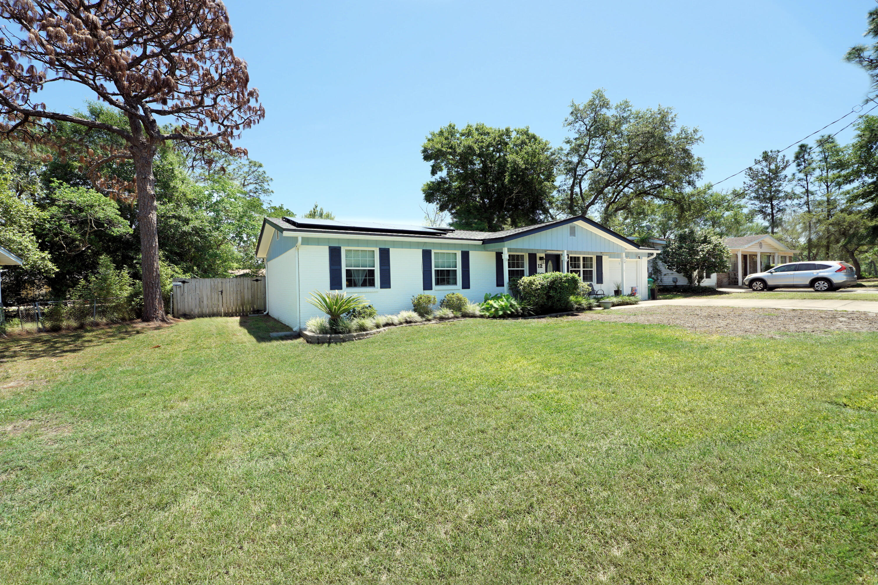 Here is your opportunity to own a home in highly desirable Shalimar, Florida! Only minutes from Eglin AFB and the most beautiful beaches along the Gulf Coast, this home is going to offer you the coastal lifestyle you're looking for! A classic Florida-style cottage, this home has four bedrooms and two full, recently renovated baths. Roof, Water Heater and HVAC have all been replaced within the last 5 years. The family room opens to the dining area and kitchen, making for an ideal entertaining space. The current owners use one of the bedrooms as a music room, as it is adjacent to the family room and is connected by french doors. Down the hall are the two other guest rooms, as well as a full bath. The primary bedroom is at the rear of the home, with an attached bath. Off of the dining area is a screened porch, which will see a lot of use! Then, you'll make your way out to the separate 12x12 screened room, which is home to a large hot tub! The backyard has privacy fencing--so grab your beverage of choice and dash out to enjoy a relaxing soak! (Click More . . .) Solar panels (FULLY PAID OFF) were added after the roof was replaced--so your electric bill is typically just the basic connection fee (approximately $30/month, with a bump in Jan & Feb to approximately $60). New sod in the front yard is thriving! Come see this gem!