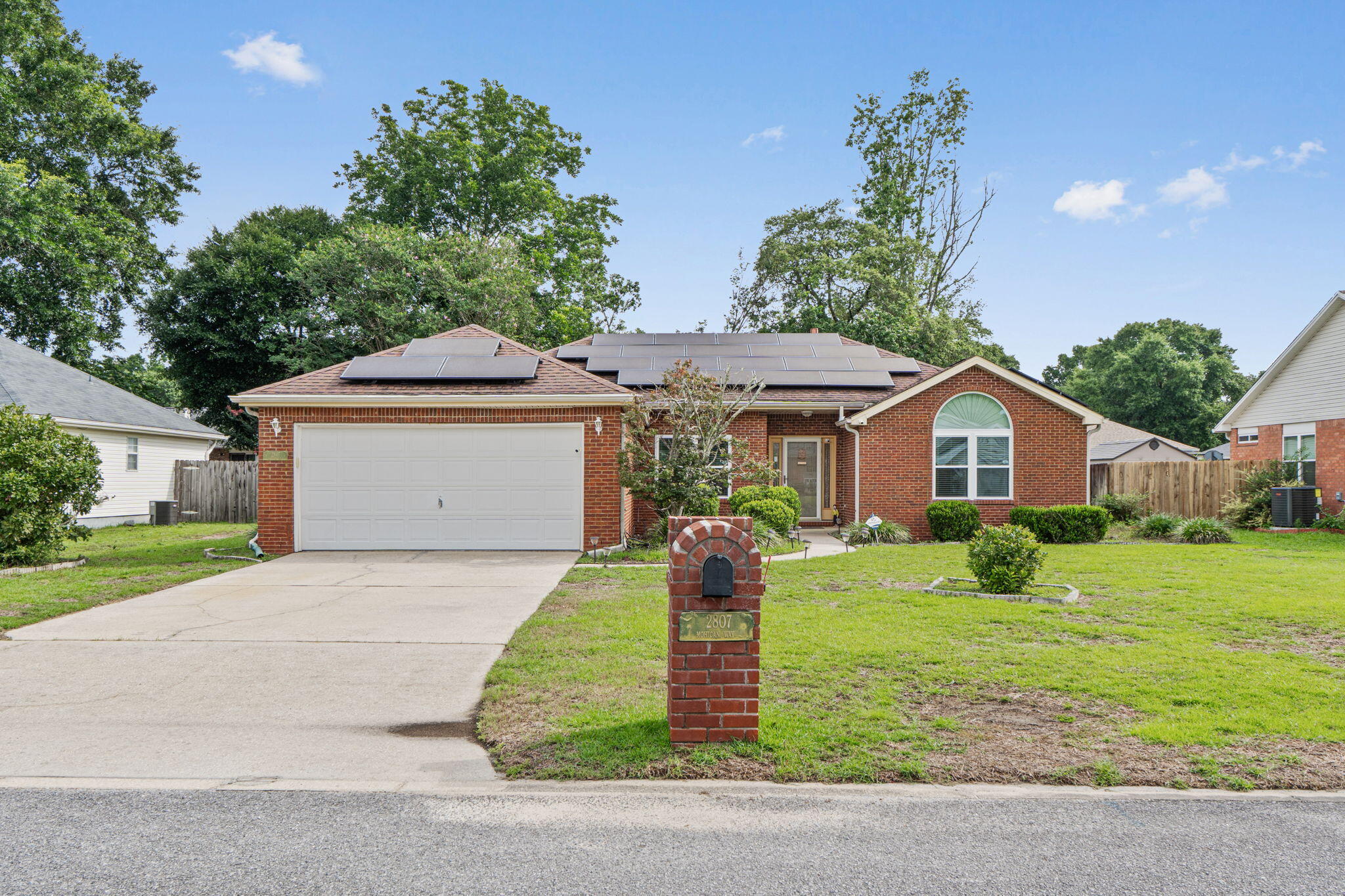 Welcome to this beautifully maintained 3-bedroom, 2-bath home in highly desirable South Crestview! Featuring a classic brick exterior and owned solar panels for added energy efficiency. A new roof will be installed with an acceptable offer. This home offers the perfect blend of comfort and style. Inside, soaring cathedral ceilings create an open, airy feel, while a cozy corner fireplace anchors the spacious living room. Beautiful laminate wood flooring flows throughout the main living areas, with tile in the kitchen and bathrooms. The living room features tiled carpet installed over the laminate flooring for added comfort and can be easily removed. The spacious kitchen offers abundant cabinetry, generous counter space, and a breakfast bar that opens to the living area, making it ideal for everyday living and entertaining. The oversized primary suite provides a relaxing retreat, while two additional bedrooms offer flexibility for family, guests, or a home office. Enjoy year-round outdoor living in the large screened-in sunroom overlooking the fully fenced backyard--perfect for morning coffee or evening gatherings. A two-car garage, mature landscaping, and convenient access to military bases, shopping, dining, and the Emerald Coast's white-sand beaches complete this exceptional property. Schedule your private showing today!