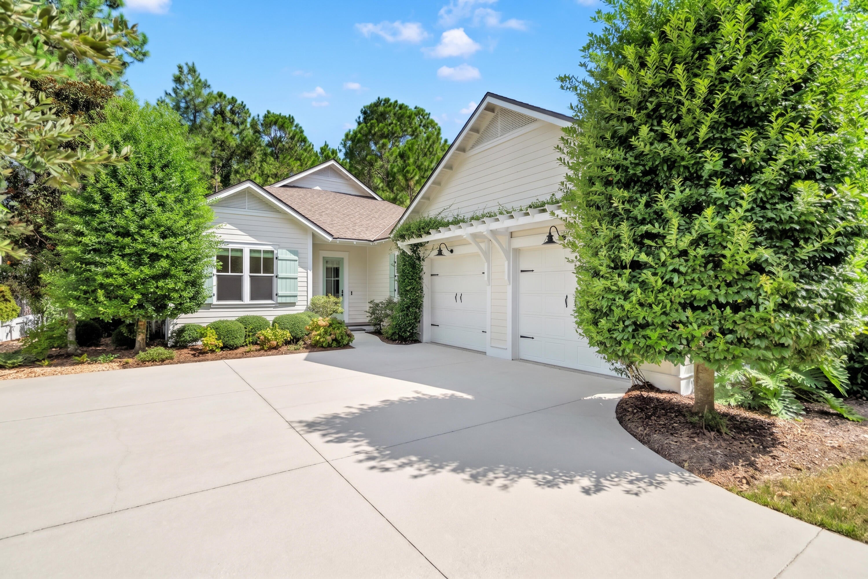Located on a premium lot in the sought-after Winter Garden phase of Watersound Origins, this immaculate 4-bedroom home is surrounded by mature trees, lush landscaping, and beautifully established streetscapes that offer character and charm that can't be found in the newer sections of the community. The spacious backyard opens to a community trail, while the screened porch provides the perfect place to relax, entertain, and enjoy the peaceful surroundings--all just minutes from the sugar-white sands and emerald waters of the Gulf. 

Here, the best of the Watersound lifestyle is right at your fingertips. Enjoy unlimited golf with no green fees (cart fees apply), a resort-style pool, fitness center, tennis and pickleball courts, playground, miles of scenic trails, and access to Lake Powell for kayaking and outdoor adventures. Everyday conveniences are just a golf cart or bike ride away at Watersound Town Center, where you'll find Starbucks, Publix, ice cream, restaurants, boutique shopping and more.

Step inside to 10-foot ceilings, hardwood floors, and an open, light-filled floor plan, where a brick fireplace creates a striking focal point in the living area. The beautiful kitchen features quartz countertops, custom cabinetry, premium appliances, a generous island, and a dedicated pantry. The dining area overlooks the backyard, creating a picturesque backdrop for meals and gatherings.