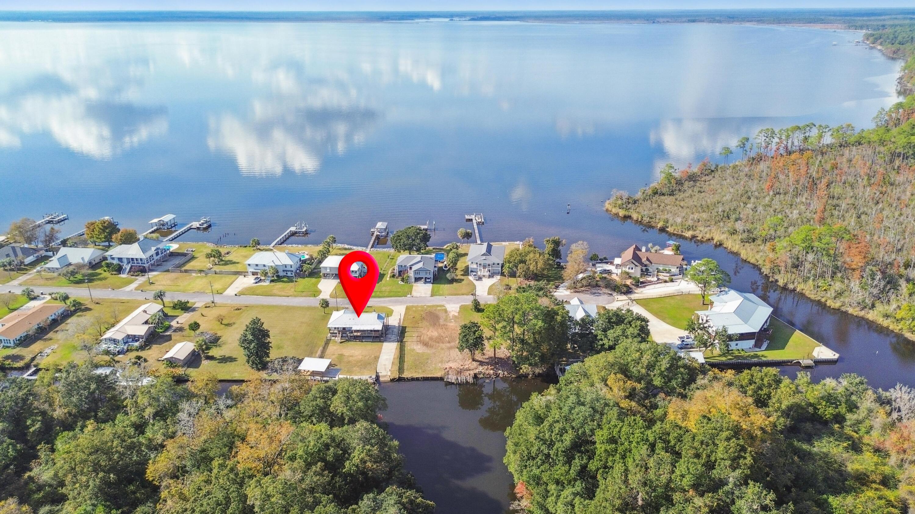 Welcome to a rare waterfront retreat offering the perfect blend of coastal charm and modern updates.

Nestled on a quiet canal with direct bay access to the Gulf, this property is a boater's paradise. Featuring a private paved boat launch and brand-new dock with boat slip, it's designed for effortless days on the water. The slip accommodates vessels up to 40 feet, and with canal depths ranging from 6-8 feet, you'll enjoy smooth navigation for fishing trips, sunset cruises, or adventures out to the Gulf.

Step onto the covered wraparound porch, where serene bay views greet you from the front, and breezy afternoons overlooking the canal await on the side and back. Whether you're sipping morning coffee or watching boats glide by, the outdoor living spaces are made for relaxation and entertaining.

Inside, the home has been thoughtfully refreshed with updated paint, vinyl flooring throughout, and a modernized kitchen and bathrooms. The kitchen features a gas stove and stylish finishes, while the bathrooms offer clean, contemporary design. Every detail has been considered to create a move-in ready home that feels both comfortable and inviting.

The exterior has been refreshed for added curb appeal, but it's the waterfront amenities that truly set this property apart. With its prime location, updated interiors, and unbeatable boating access, this isn't just a homeit's the ultimate Florida lifestyle.