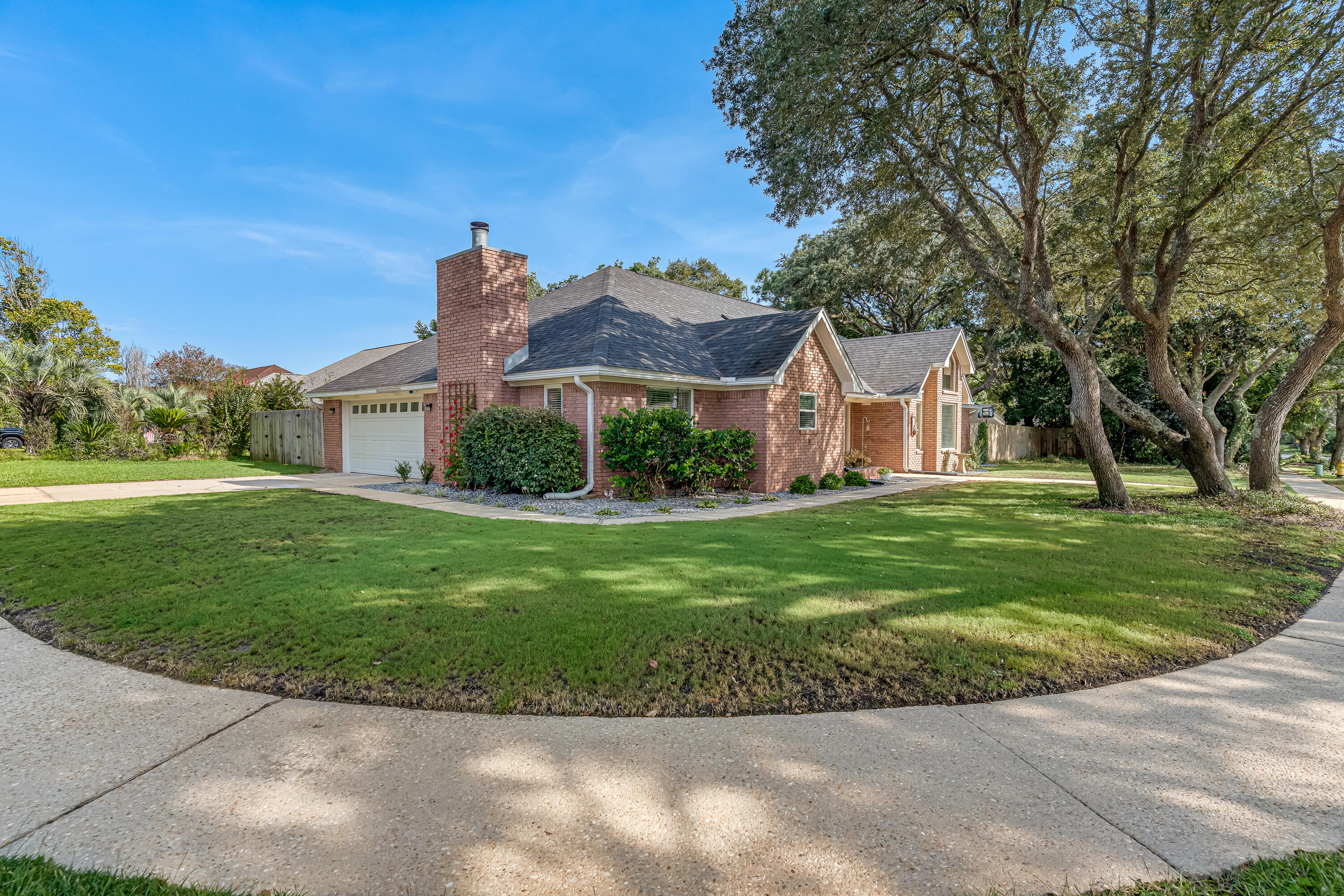 This charming three-bedroom, two-bath, single-story brick home combines timeless style with modern upgrades. Inside, you'll find luxury vinyl plank flooring flowing throughout the open floor plan, anchored by a cozy fireplace and soaring vaulted ceilings. The chef-inspired kitchen features stone countertops, a custom backsplash, stainless steel appliances, a farmhouse sink, a spacious pantry, and a large peninsula perfect for gatherings.
The primary suite is a retreat with custom molding and paint, plush carpeting, a designer vanity, a relaxing soaking tub, and a roomy walk-in closet. Additional bedrooms offer comfort and versatility.
Step outside to enjoy the fully fenced backyard, complete with mature trees, a storage shed, and an inviting back patio with an extended pergola--ideal for outdoor entertaining or quiet relaxation. Make this custom Navarre home yours today! Contact us today for a showing!