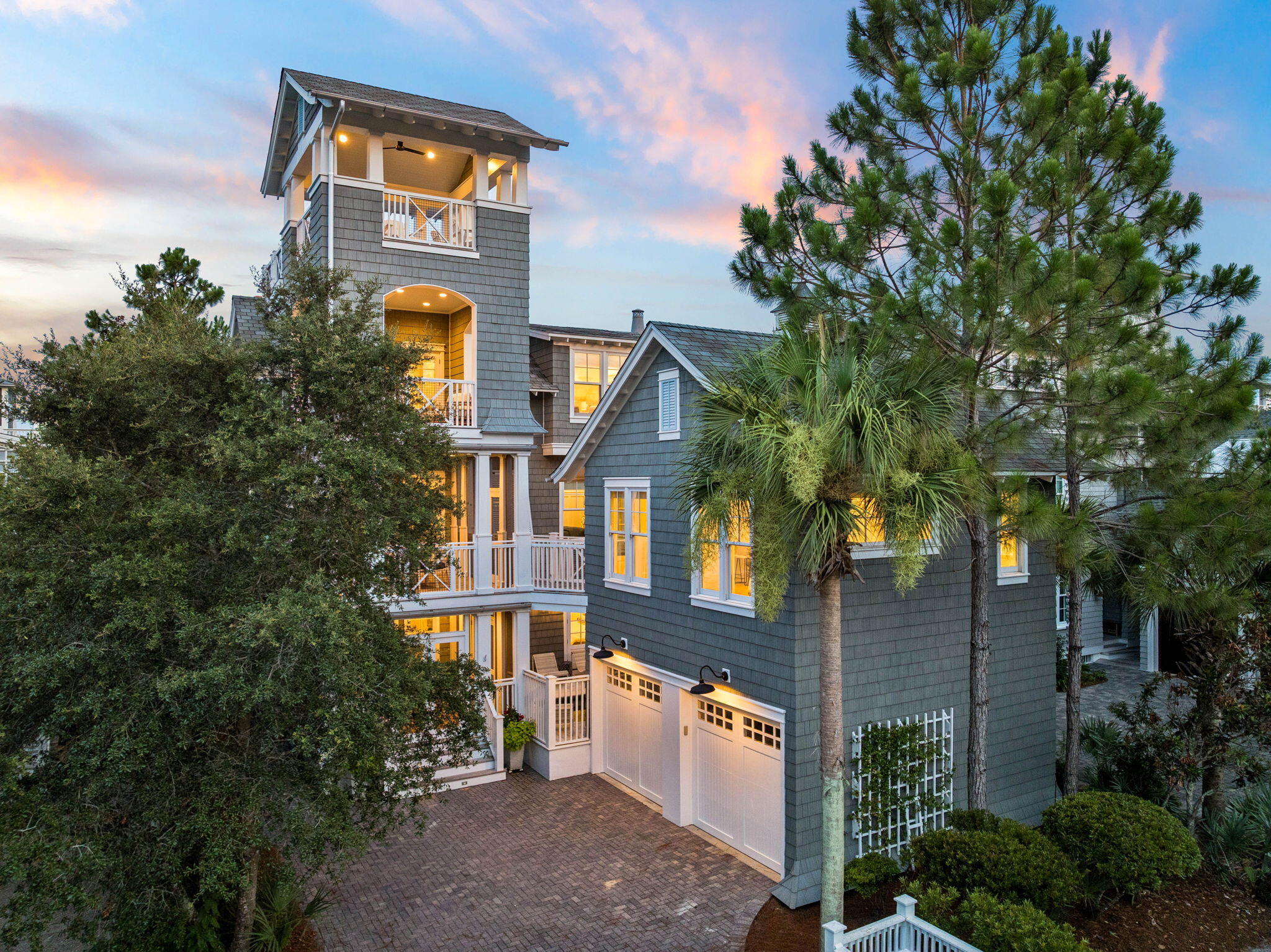 Behind the private gates of WaterSound Beach, 51 Shingle Lane offers panoramic Gulf and dune views from the double deck tower, located right on the boardwalk to a mile of private beach. And if you would rather drive your golf cart to the beach, the driveway sits 100 yards from the golf cart path. This completely refreshed six-bedroom compound with a private heated pool was updated top to bottom in 2023.
The first floor welcomes guests with a casual living room, two ensuite king bedrooms, a bunk room with four beds, and a laundry room with a drink refrigerator. An elevator serves all three floors, so luggage, groceries, and multiple generations move through the home with ease.
Up one level, the great room soars to 20-foot vaulted ceilings, anchored by a 12-foot island kitchen and a corner gas fireplace, with a screened dining porch off the main level and a deck with an outdoor fireplace overlooking the boardwalk just below. The kitchen is built for serious entertaining: brand new Thermador range, two dishwashers, refrigerator drawers, ice maker, and a wine cooler. An ensuite king bedroom and a second laundry room sit on this same level.
The primary suite occupies the third floor, where Gulf views greet you from the private deck. It includes a marble bath, private office nook, Juliet balcony overlooking the great room, his-and-hers closets, and a second wine cooler as you head up to the tower.
The carriage house guest suite with vaulted ceilings sits above the two-car garage: king bed, full kitchen, and full bath, accessible by private stair or bridge from the main home.
The 2023 refresh includes all new HVACs, water heaters, whole-home generator, refinished floors, interior and exterior paint, all new furnishings, bedding, art, and pool decking. Sold fully furnished and ready for your family to enjoy.