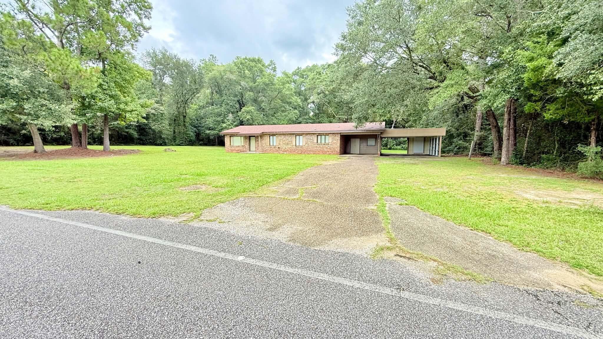 This 1650 sqft home offers generously sized rooms and the warmth and character of stained tongue-and-groove wood walls throughoutmuch of the home. Welcoming you with a large den for family time, it has 3 BR, a large dinning family area looking over the kitchen aswell as a large addition on the back of home that would be perfect to work from home or a large master suite. The large backyardfeatures a poured concrete slab already in place for a future workshop, hobby space. Situated on a great flat lot that is 0.67 of an acrehas large shaded by mature oak trees, offers a peaceful setting with plenty of usable outdoor space for running, playing and even a garden area. Located near downtown Florala which also allows golf carts for commuting in town, parks and lake and just a short drive to Eglin AFB and Crestview, FL. If you're looking for space, character, and a great location, this home is ready to welcome you! The price gives you the opportunity to turn this home into your own!