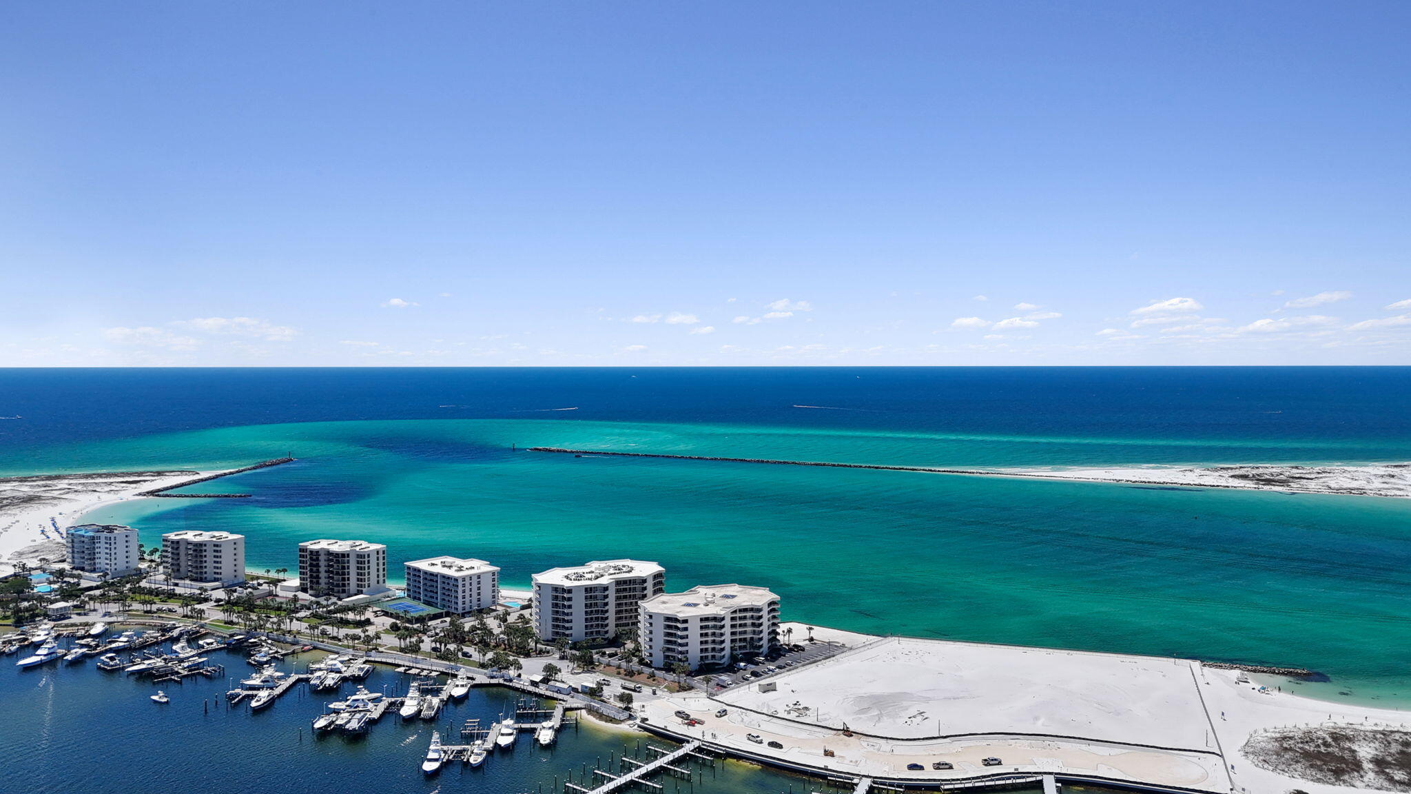 Welcome to East Pass Towers, where the best of Destin's beach, boating, and harbor lifestyle come together in one incredible location. Recently refreshed with fresh paint, updated furnishings, and thoughtful cosmetic improvements, this condo is ready to enjoy as your beachside getaway, primary home, or investment property as this building allows short term rentals. 

Perfectly positioned on Holiday Isle at Norriego Point, this gated waterfront community offers spectacular surroundings with views of the Gulf, Destin Pass, Destin Harbor, the jetties, and Destin's iconic bridge at Crab Island.  Watch the boats cruise through the Pass, spend the day on the water, or catch a water taxi across the harbor to the restaurants, entertainment, and nightlife of HarborWalk Village.  End your summer nights with a firework show so close it seems it was just for you and your guests.

Boaters will love having East Pass Marina directly across the street, with boat slips available for purchase or rental, subject to availability. Prefer your days in the sand? East Pass Towers offers its own Pass-front beach, while local favorites, Norriego Point and O'Steen Beach, are just east of the complex.
Adding to the unique setting, the State of Florida has recently purchased the adjacent parcel next to the property, further distinguishing this special location at the end of Holiday Isle. Whether your perfect Destin day means boating, fishing, paddle boarding, relaxing on the beach, watching the sunset, or heading across the harbor for dinner, East Pass Towers puts you in the middle of everything that makes the Destin lifestyle so special.