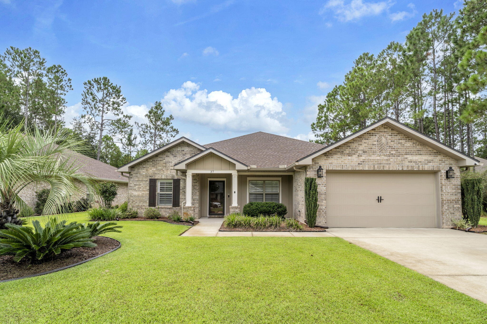 Stunning custom-built lakefront home in Freeport, Florida, offering 4 bedrooms, 3 bathrooms, and 2,359 square feet of thoughtfully designed living space. The spacious split-bedroom floor plan provides both comfort and privacy, while the open-concept living room and kitchen create an inviting space for everyday living and entertaining. A beautiful fireplace adds warmth and character to the main living area. The impressive primary suite is a private retreat, featuring a spa-like bathroom and expansive walk-in closet. The second bathroom is beautifully appointed with a custom shower. Step outside to the custom patio and enjoy peaceful lakefront views, with a motorized outdoor screen creating the perfect setting for relaxing or entertaining. The large fenced backyard provides ample room for pets, play, gardening, or enjoying the outdoors. Additional upgrades include a Lorex Security System and Reme Halo LED In-Duct Air Purifier for added comfort and peace of mind. Combining custom craftsmanship, spacious interiors, thoughtful upgrades, and tranquil lakefront living, this exceptional home offers a wonderful opportunity to enjoy the best of the Florida lifestyle.