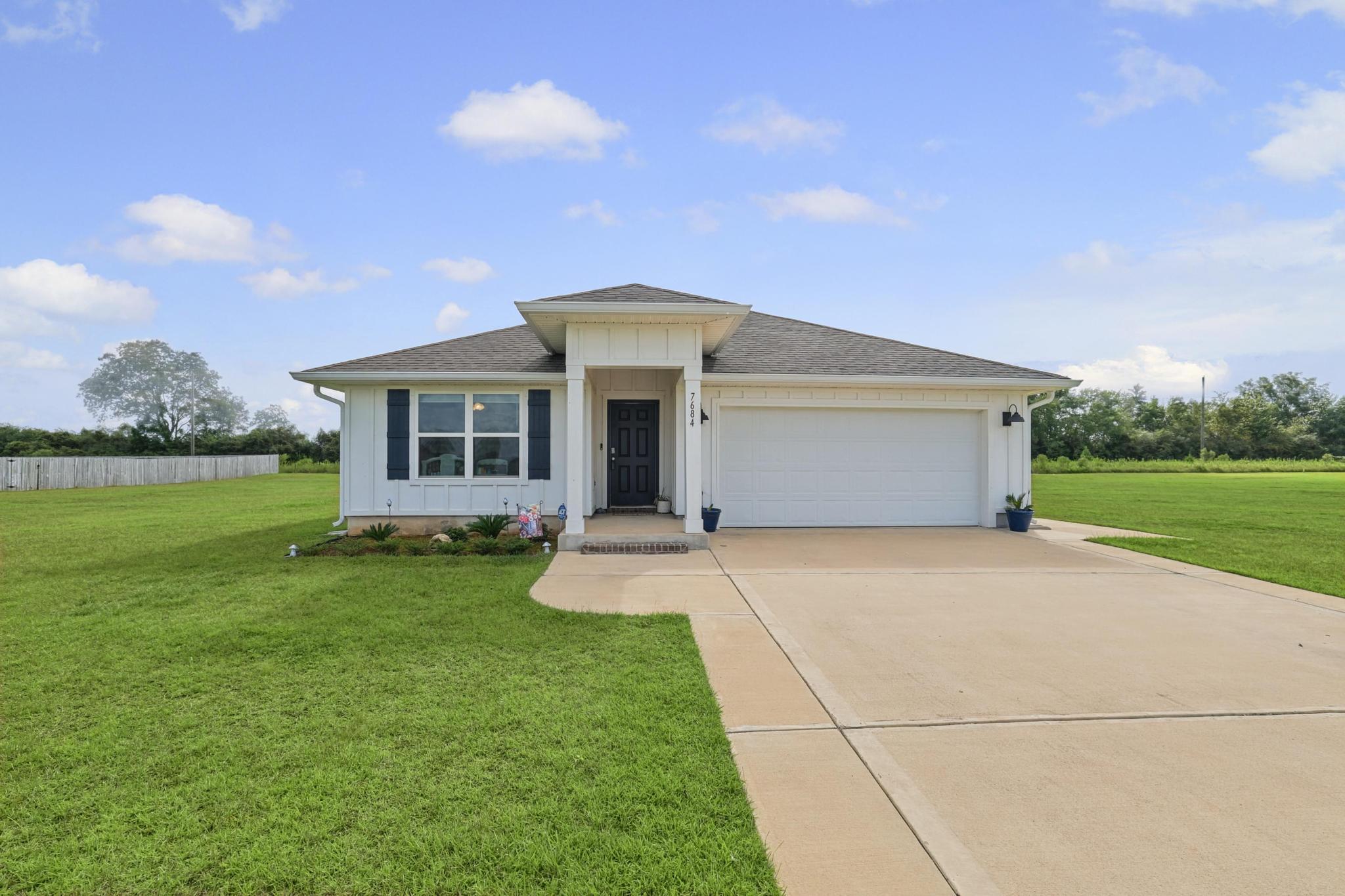Welcome home to this spacious 4-bedroom, 2-bathroom property offering 1,768 square feet of comfortable living space on an oversized 1.01-acre lot. From the moment you step inside, you'll appreciate the light, inviting colors throughout the home. The kitchen features crisp white cabinetry, a center island, and a convenient dining area, creating a welcoming space for everyday living and entertaining.

Thoughtfully designed, the bedroom layout provides comfort and convenience for family and guests. Step outside to enjoy the covered rear patio overlooking the expansive lot, offering plenty of room to relax, entertain, garden, or simply enjoy the outdoors.

Ideally located close to shopping, dining, and everyday conveniences, this property offers the perfect combination of space, comfort, and accessibility an added bonus for enjoying the coastal lifestyle.