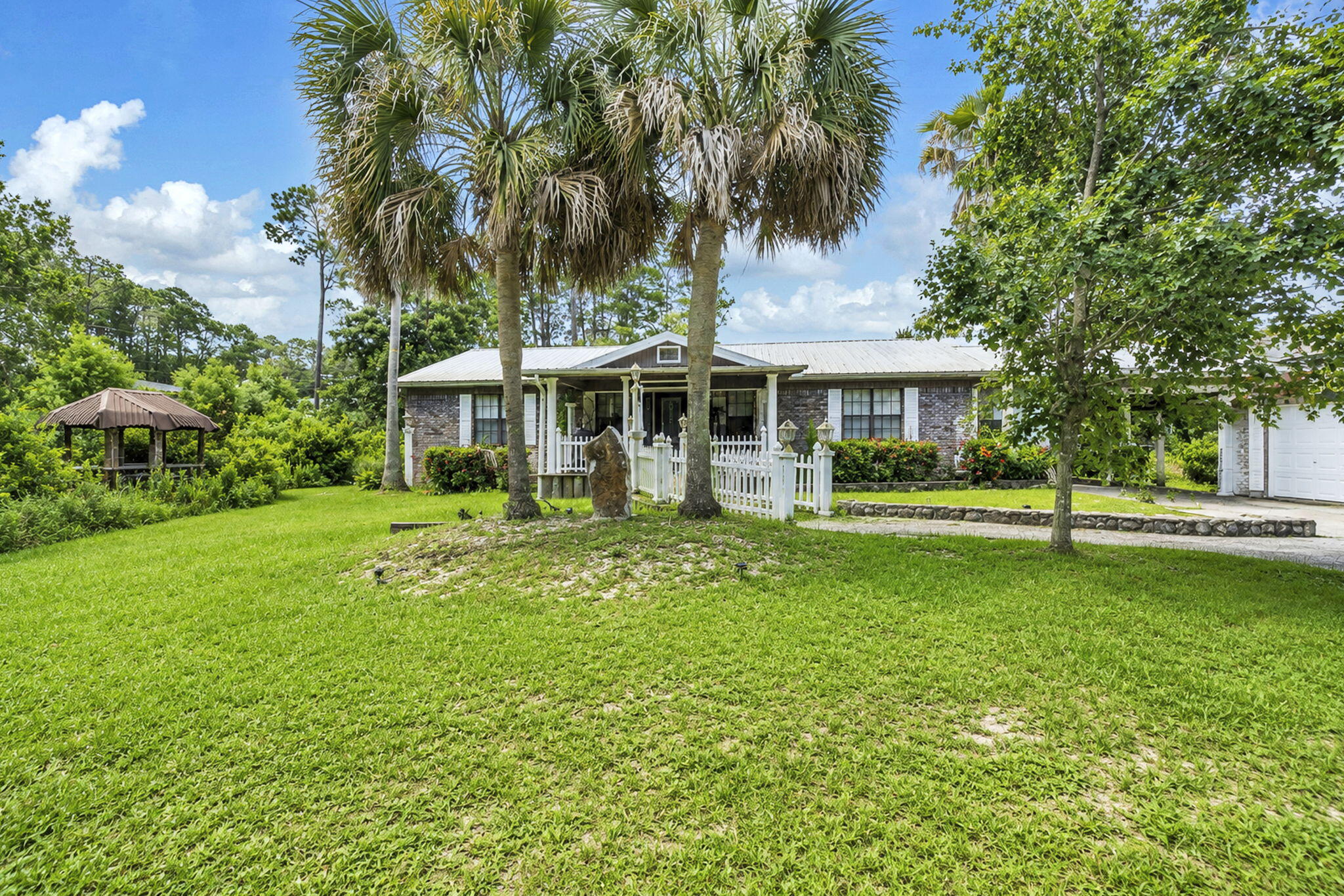 Ranch Style brick home, 3/2 with small pool on two private lots with a total of .831 acres.   On private road with just one other house. Attached 2 car garage and 1/2 mile to beach access.  Zoned residential preservation with short term rentals allowed per the county. ADU can be added to the property also. Bathrooms and kitchen have been renovated but property needs further work. Great project house for someone looking for a larger lot that you can take your golf cart to the beach from. As-is sale.