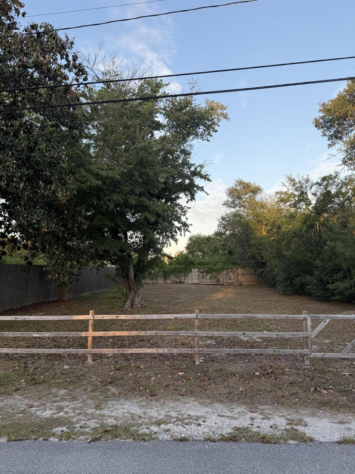Fenced in cleared lot ready to be built on or mobile home to be placed. Lot has septic on site. Previously had services for water and electric will need to have services in place cleared for re-use. Nice shady trees on land was a previously established residence and cleared. Land/home purchase or construction loan package financing for VA, FHA, or conventional is available, lot loan, cash. Beach access less than 5 minutes away just south of hwy 98. Easy access.