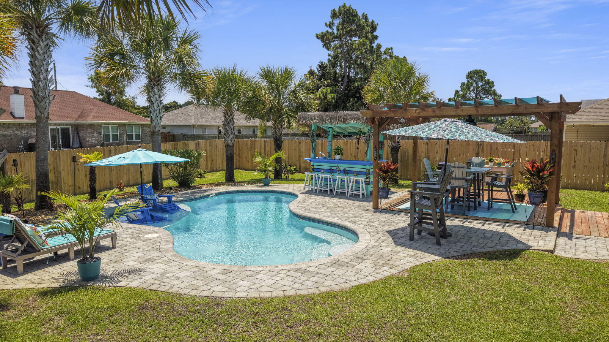OPEN HOUSE SATURDAY 6/27 9am to 11:30 am. Welcome to your own private Florida retreat! This beautifully maintained 3-bedroom, 2-bath home offers the perfect blend of comfort, style, and outdoor living. The open-concept floor plan features a spacious living room with recessed lighting, creating a bright and inviting space for entertaining or relaxing with family.

The kitchen is designed to impress with granite countertops, stainless steel appliances, and plenty of workspace for meal preparation and gatherings.
Step outside into your backyard oasis, where you'll find a sparkling Gunite in-ground pool surrounded by swaying palm trees and a charming tiki hut--perfect for hosting friends, or unwinding after a long day.
Additional features include energy-saving solar panels to help reduce utility costs, underground utilities, public water and sewer, gutters as well as hurricane shutters. Just 8.5 miles from the sugar-white sands and emerald waters of Navarre Beach. Whether you're looking for a primary residence, vacation home, or investment property, this home offers the Florida lifestyle you've been dreaming of.